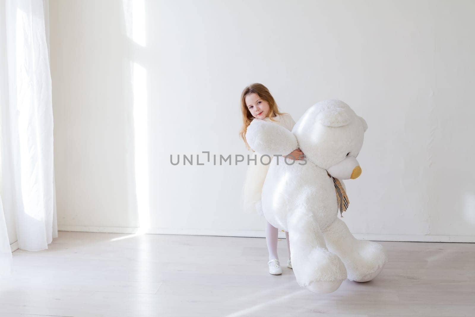 Beautiful little girl with toy big bear