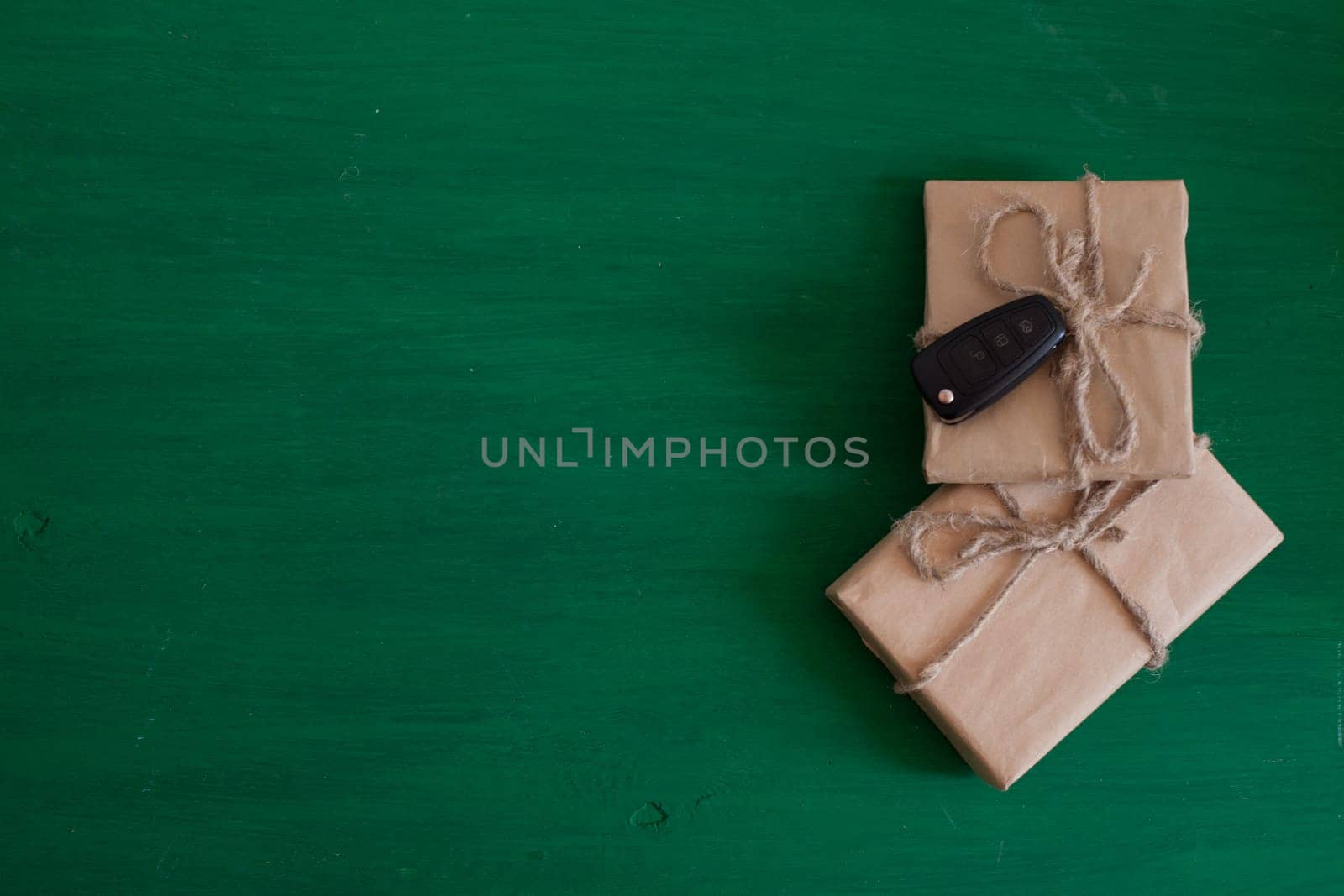 gifts and car keys on a green background by Simakov