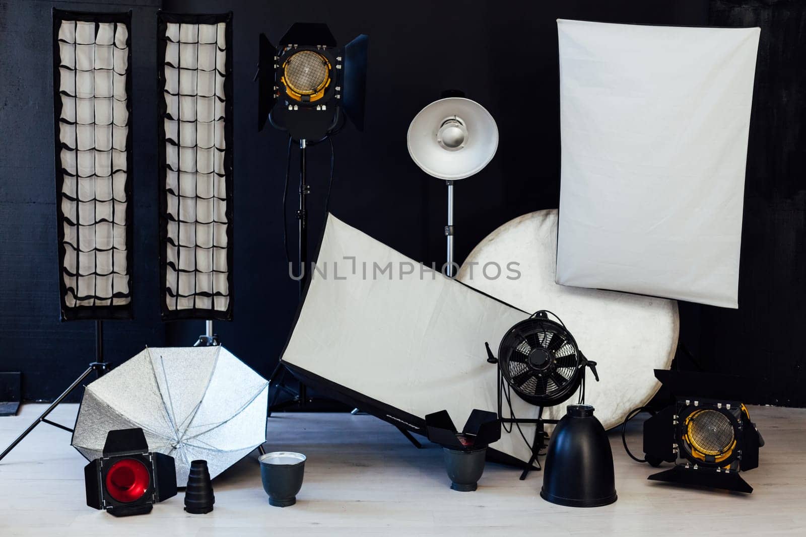Photo studio equipment flash accessories photographer on black background by Simakov