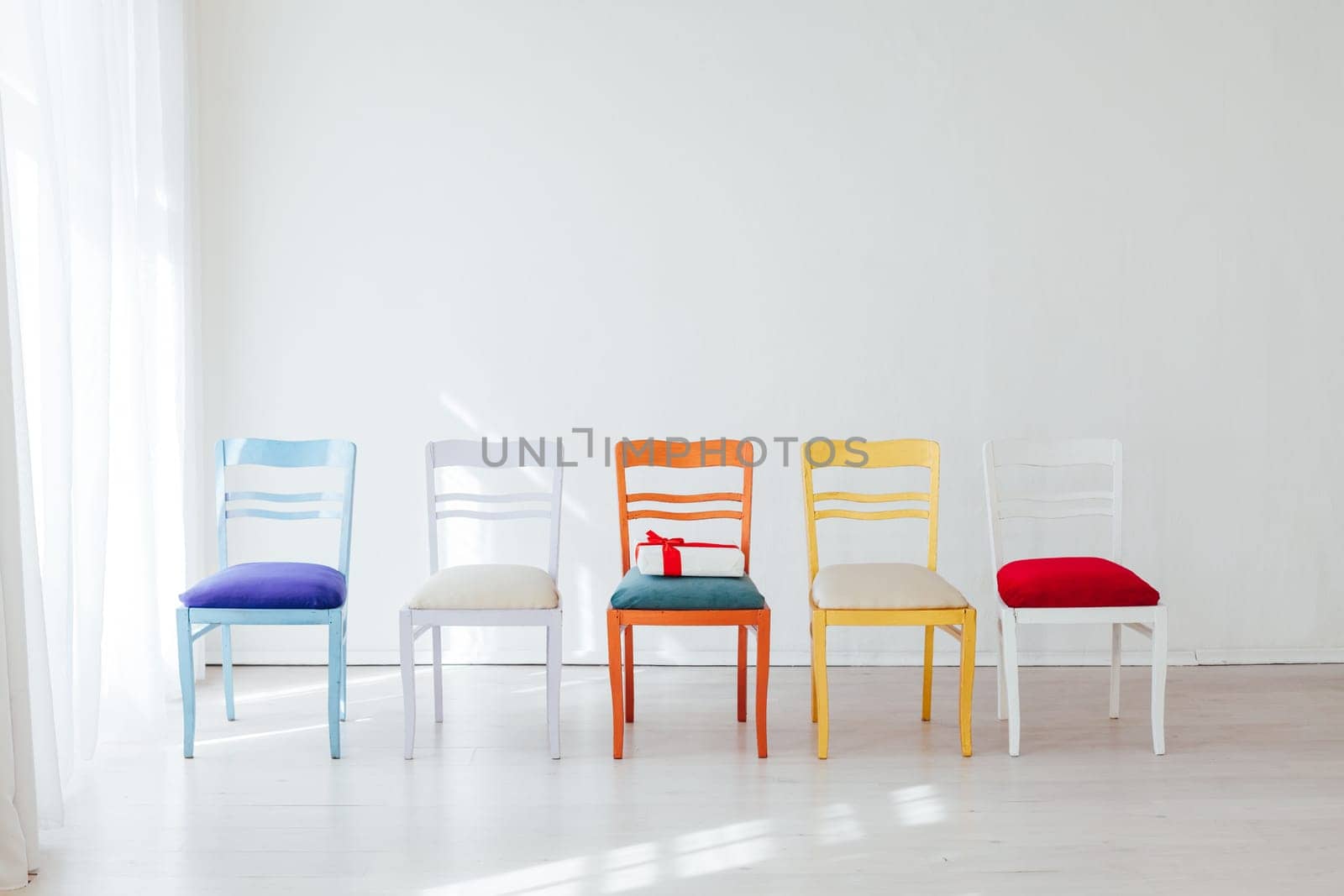 four chairs of different colors in the interior room