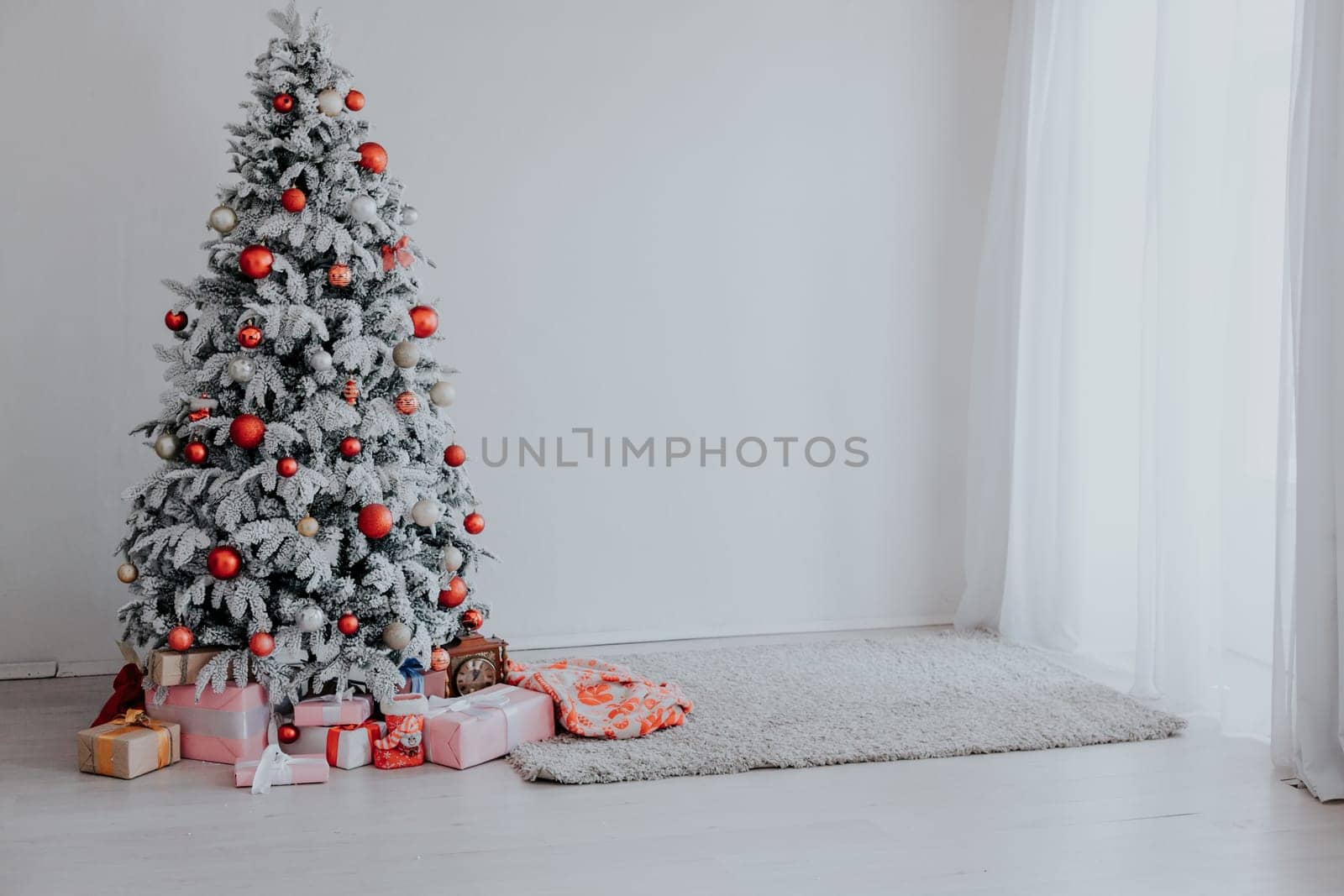 Christmas Decor Christmas tree with presents in a white room