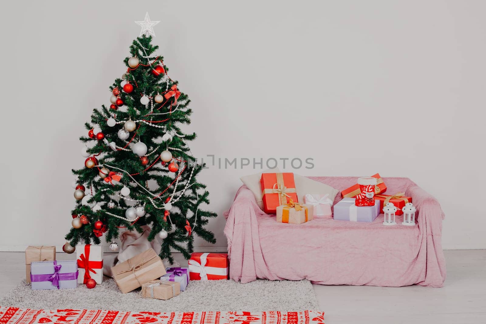 Christmas tree in a white room with Christmas decorations and gifts toys by Simakov