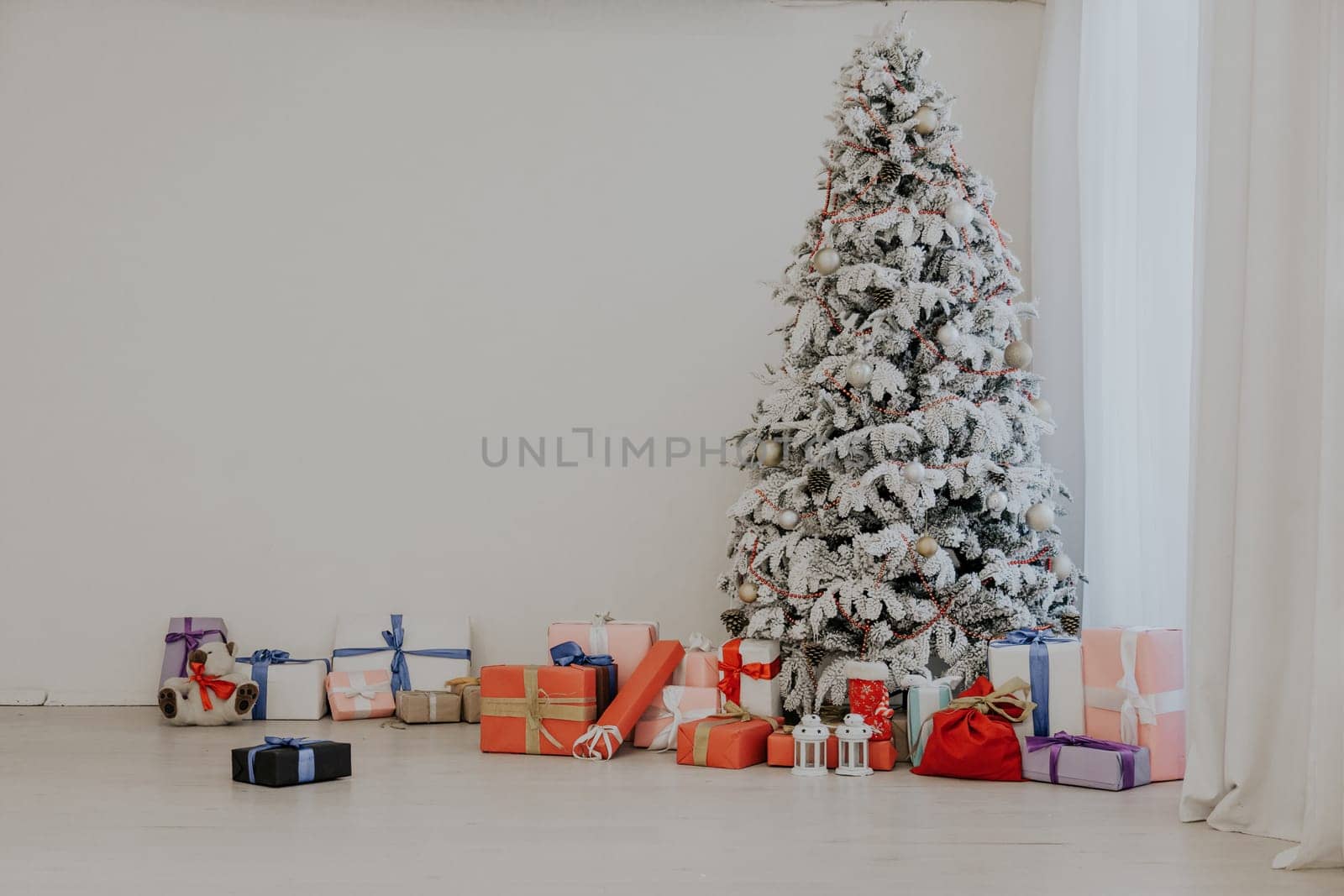 the Interior of the white room with a Christmas tree and Christmas gifts by Simakov
