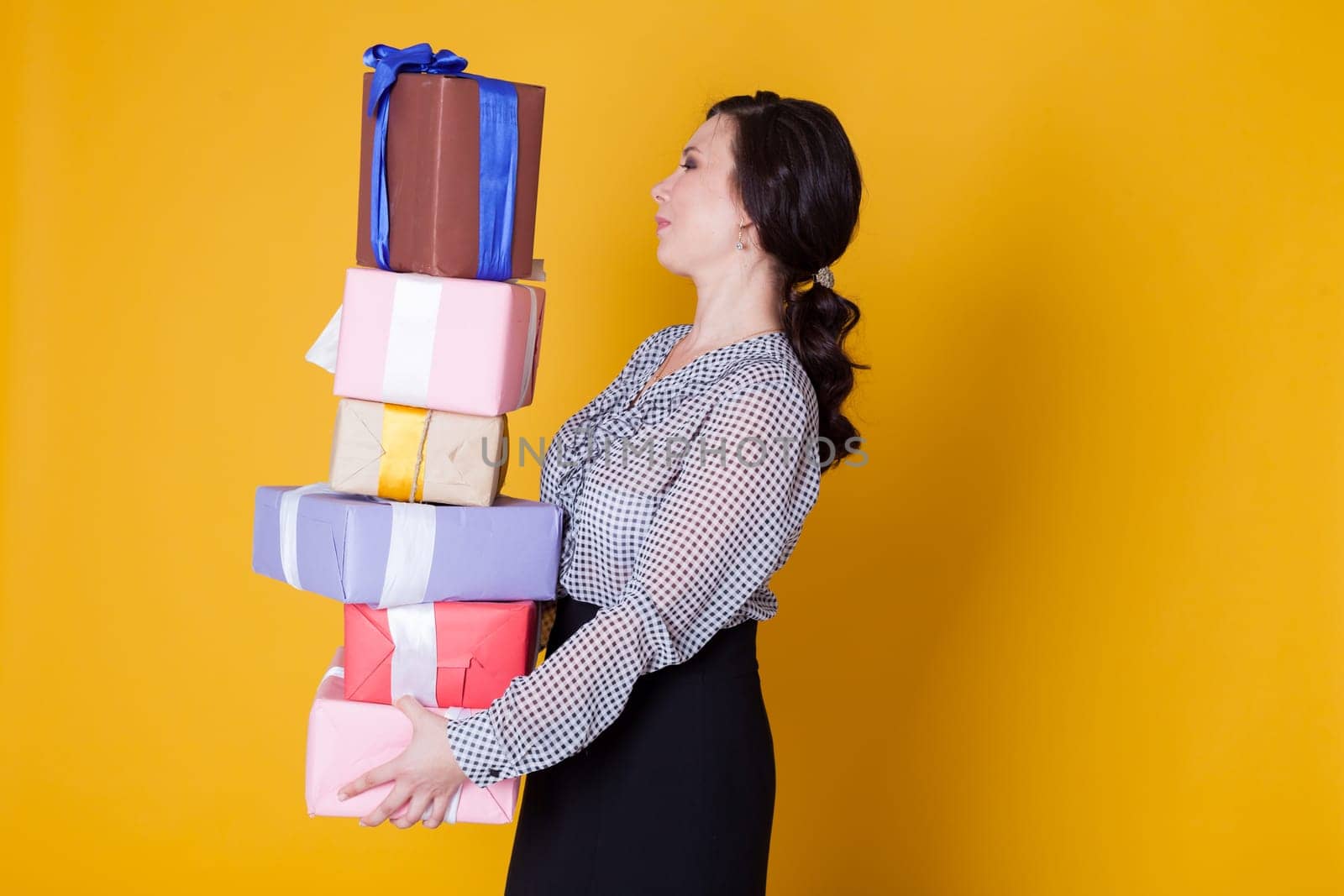 woman holds holiday gifts for her birthday