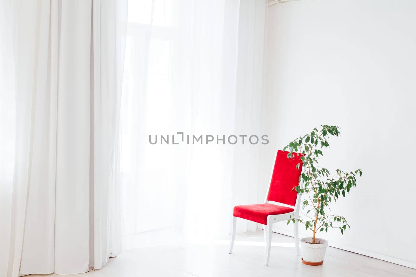 red chair in the interior of an empty white room by Simakov