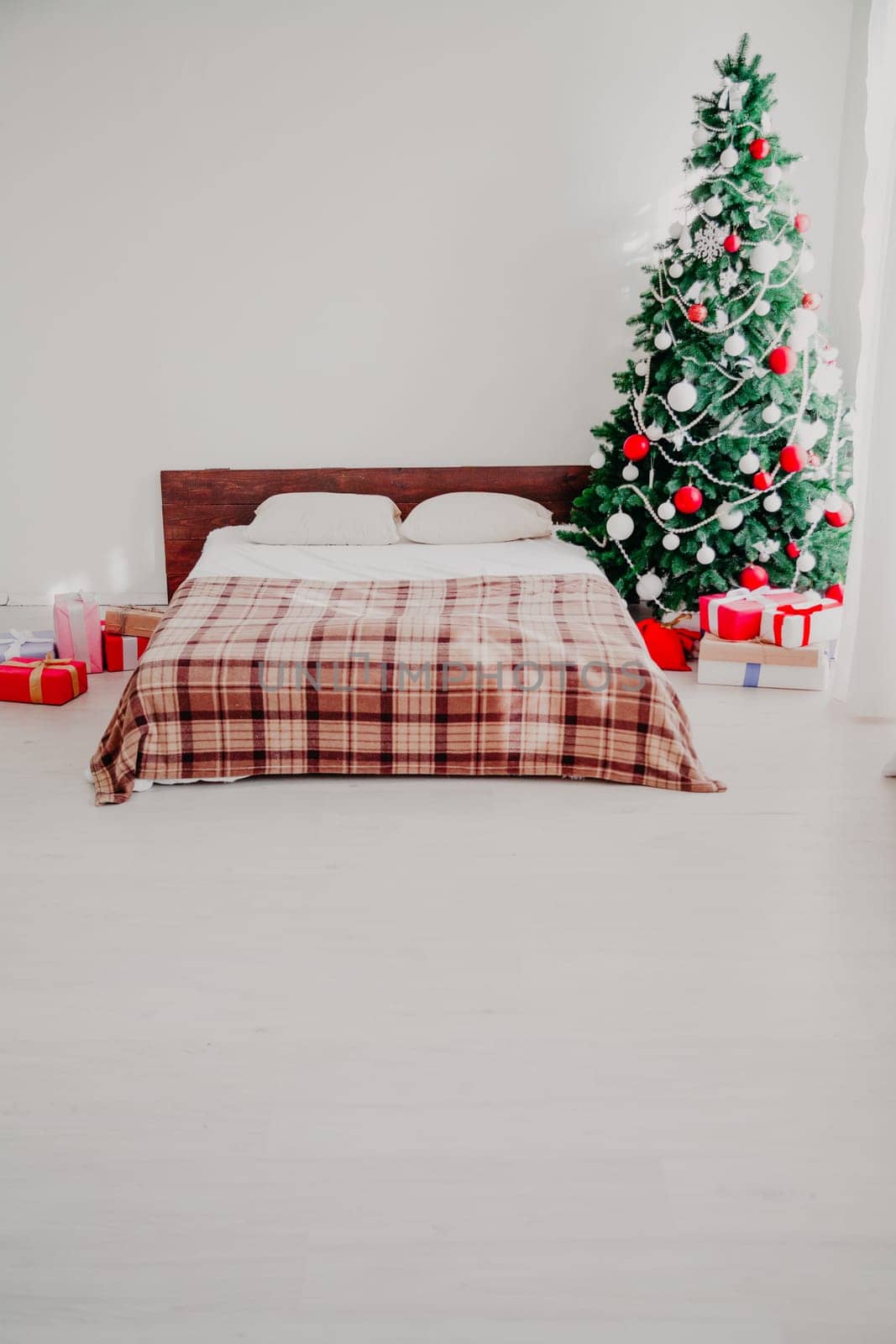 Interior bedroom with bed and Christmas tree new year holidays