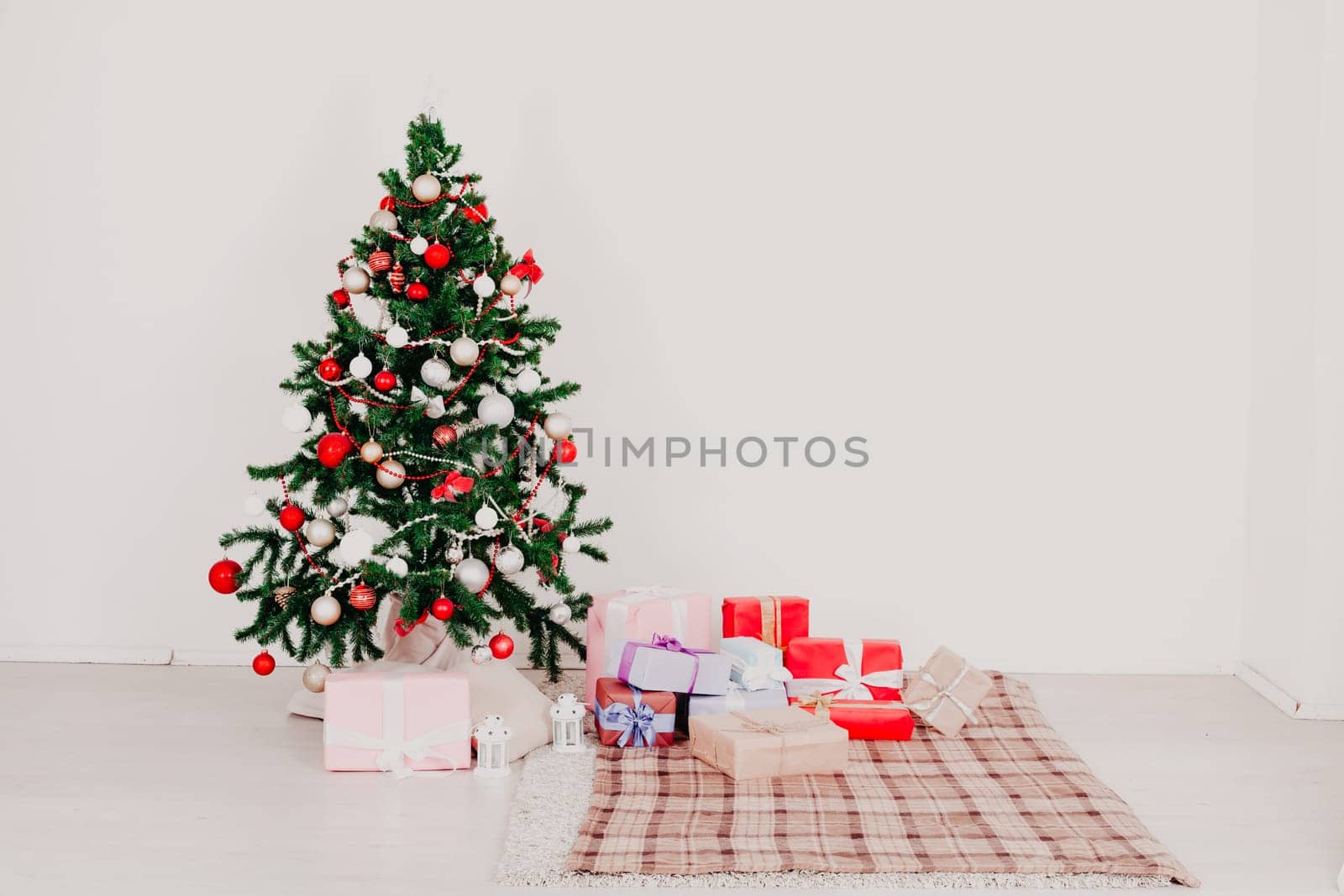 Christmas tree in white interior with toy stuffers decor