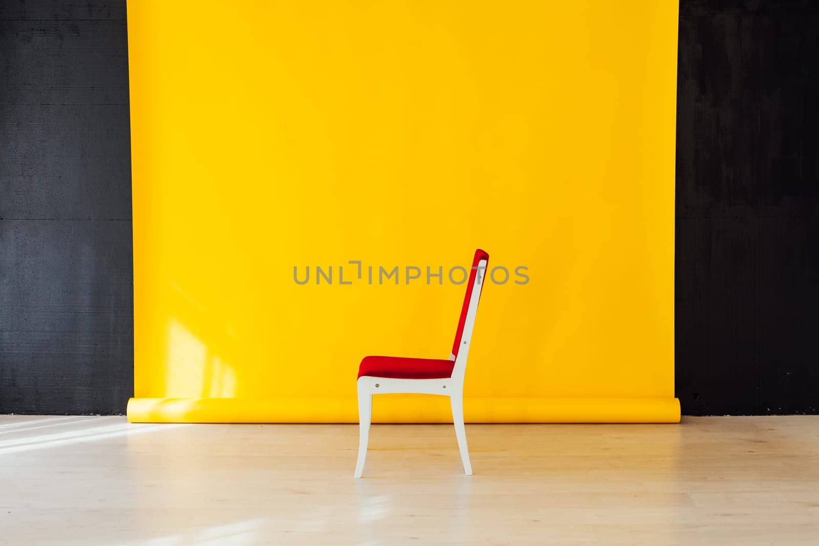 one red chair in the interior of the room with a yellow background by Simakov