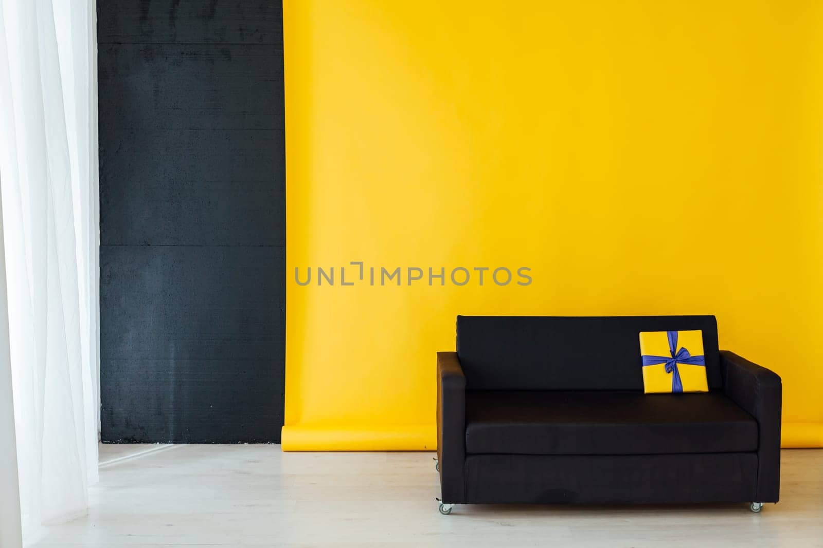 office sofa with gifts in the interior of the room with a yellow background by Simakov