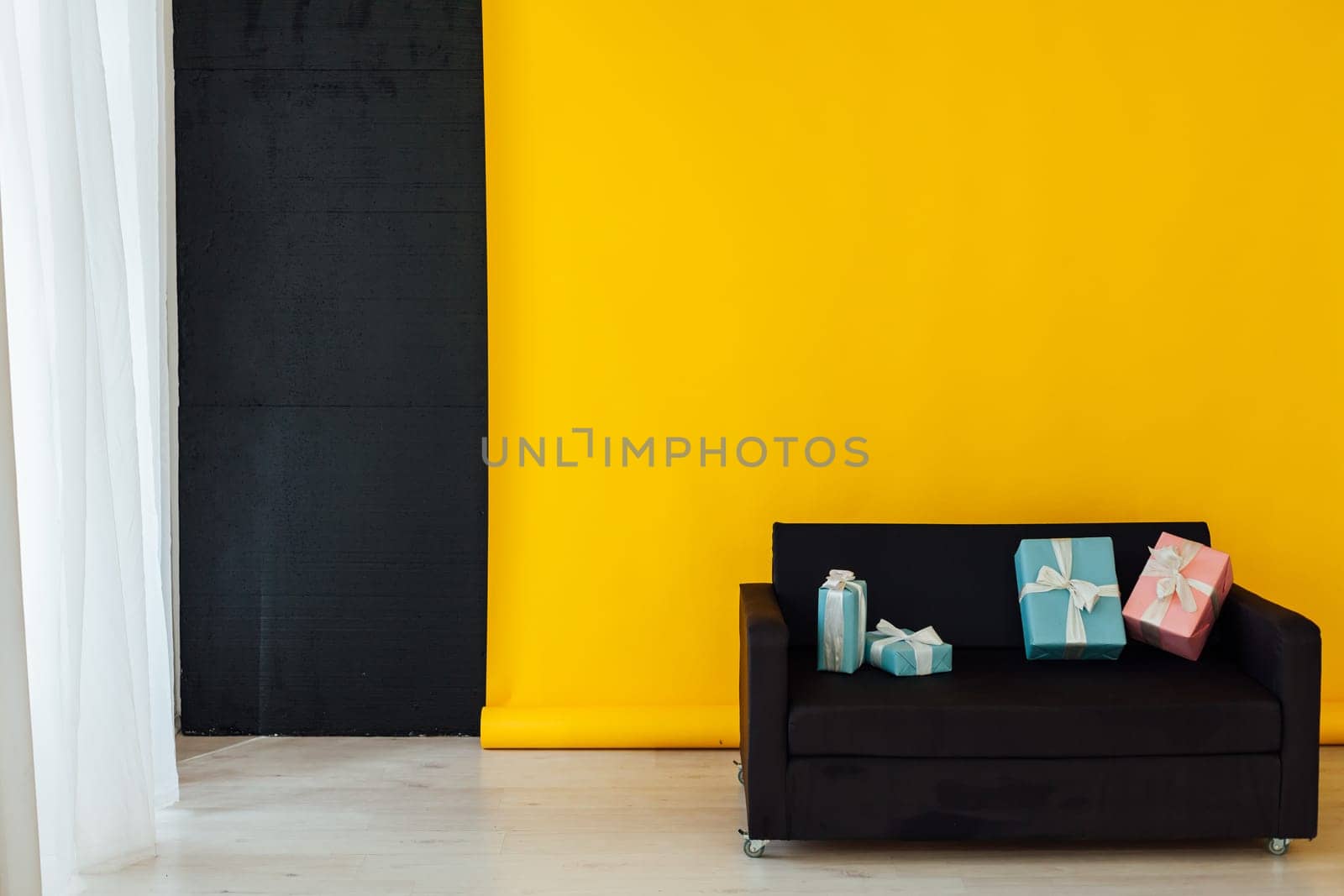 office sofa with gifts in the interior of the room with a yellow background by Simakov