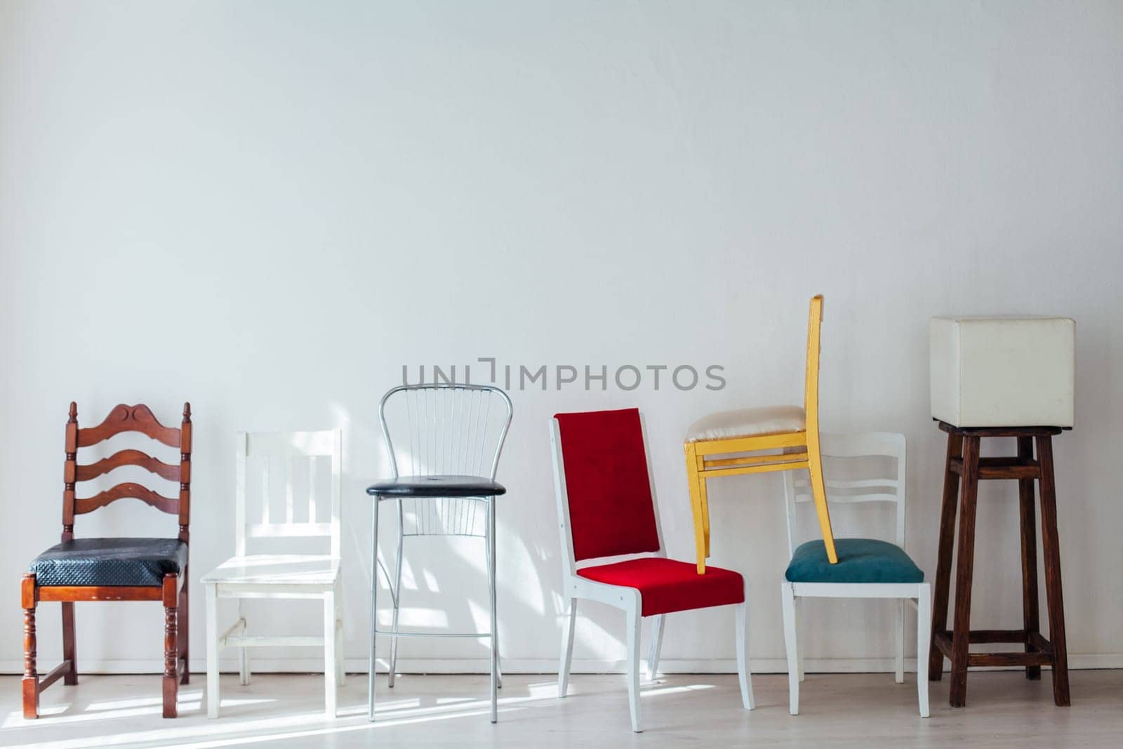 lots of different chairs in the interior of the white room by Simakov