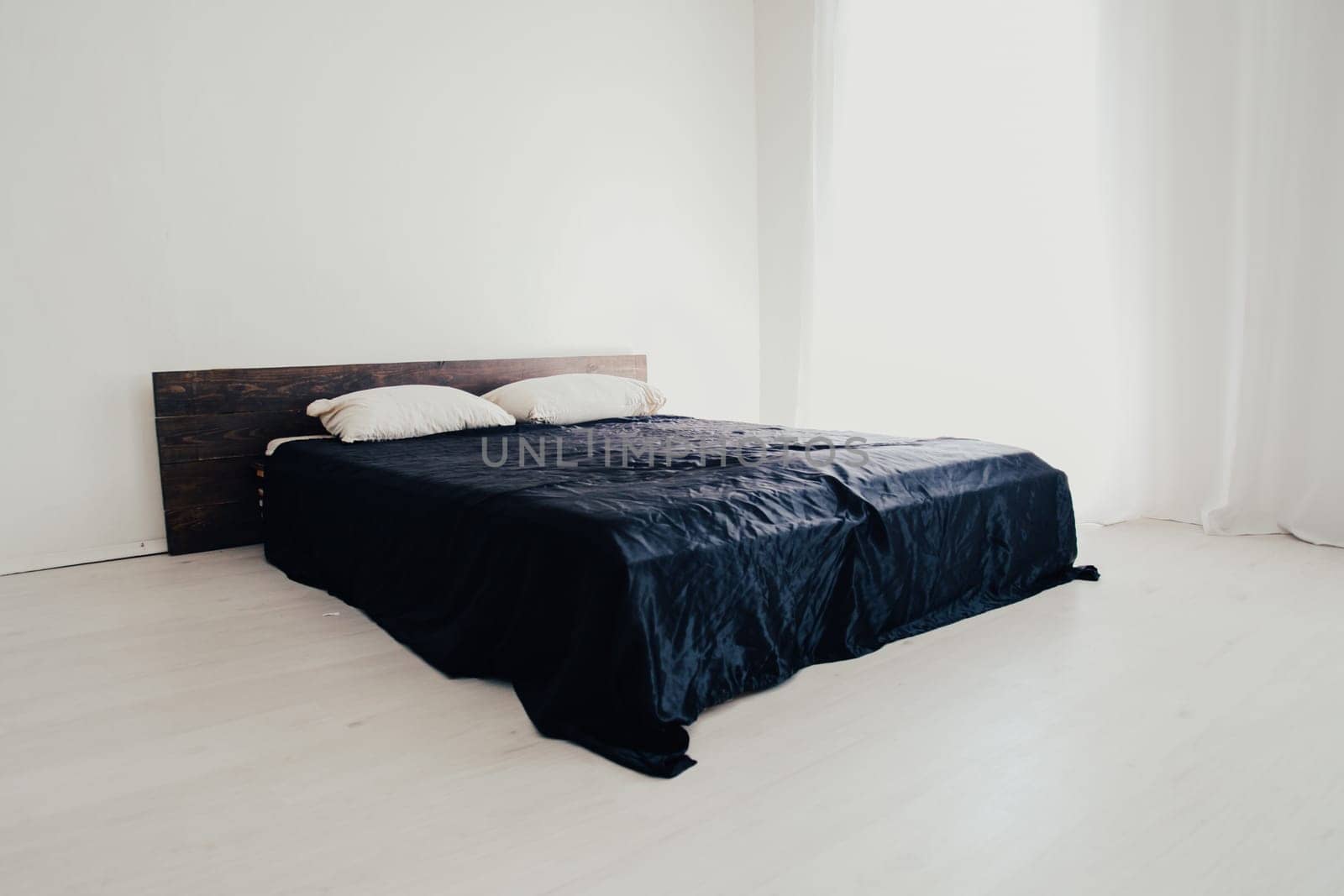 Interior white bedroom and bed with black sheets by Simakov