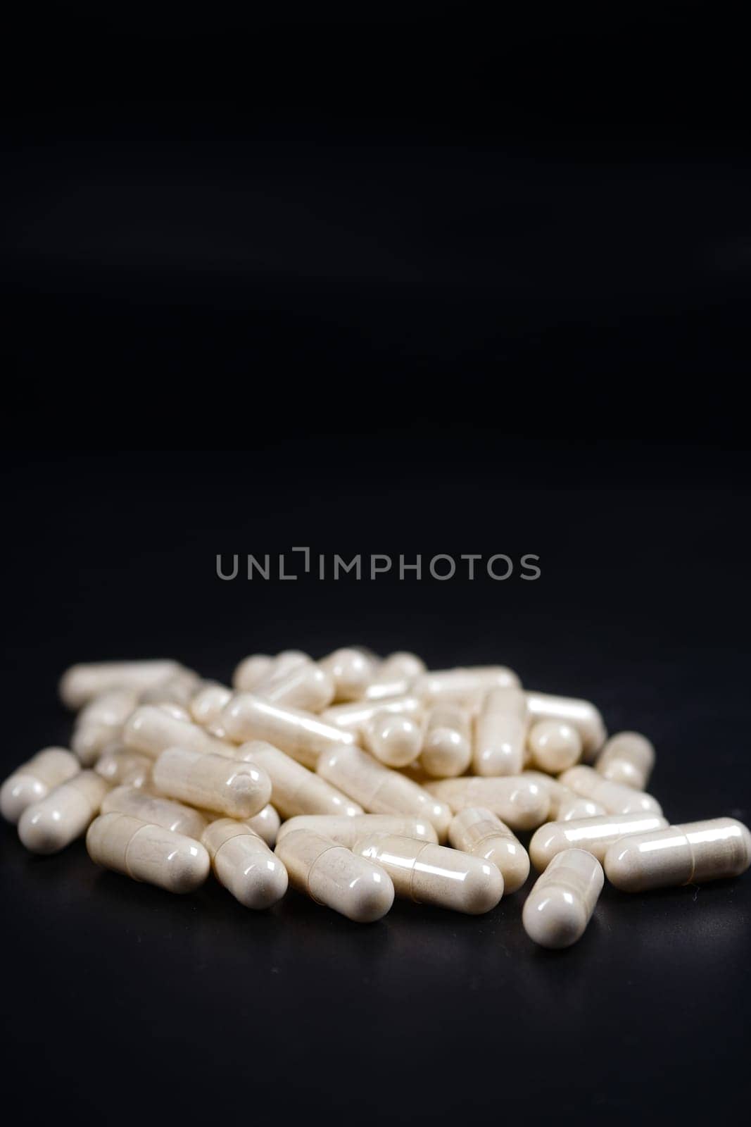 herbal medicine capsule on black background .