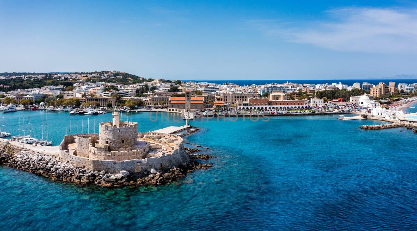 Mandraki port with deers statue, where The Colossus was standing and fort of St. Nicholas. Rhodes, Greece. Hirschkuh statue in the place of the Colossus of Rhodes, Rhodes, Greece