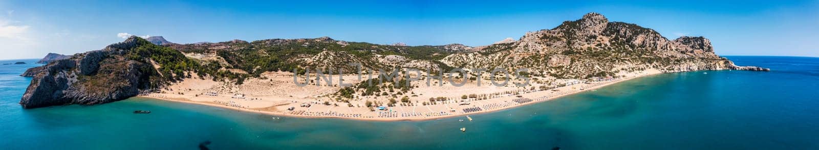 Tsampika beach with golden sand view from above, Rhodes, Greece. Aerial birds eye view of famous beach of Tsampika, Rhodes island, Dodecanese, Greece