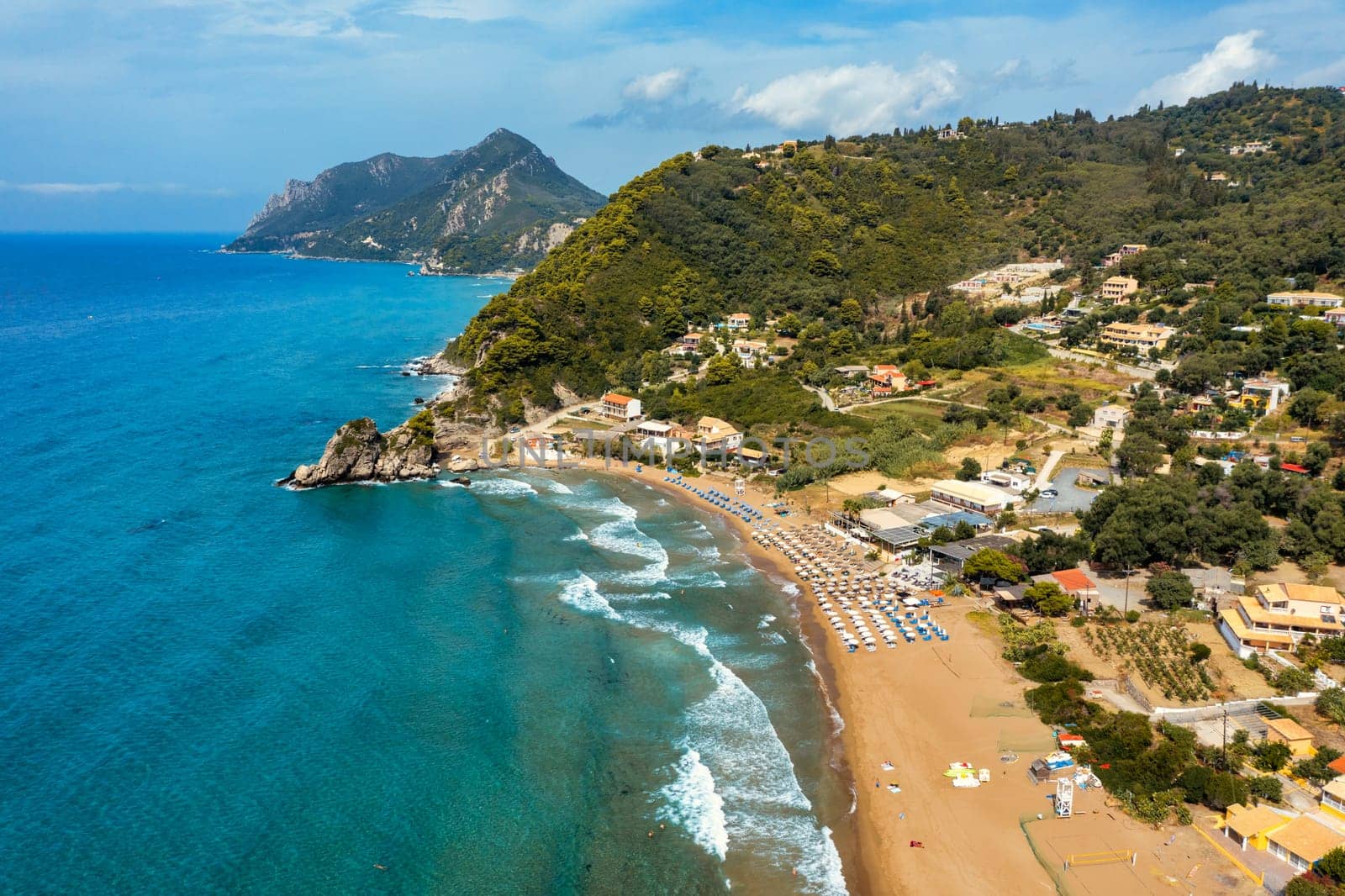 Aerial drone view over western coast and Glyfada beach, Island of Corfu, Greece. Glyfada Beach at Corfu Greece during the day. 