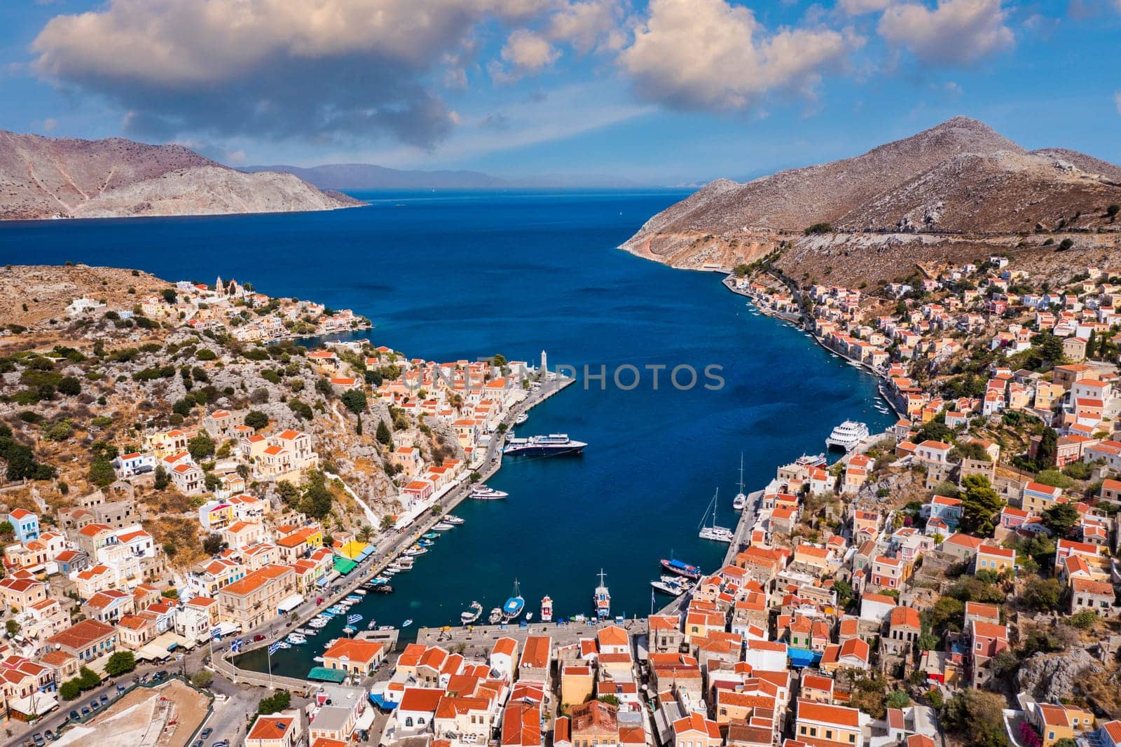 Aerial view of the beautiful greek island of Symi (Simi) with colourful houses and small boats. Greece, Symi island, view of the town of Symi (near Rhodes), Dodecanese.