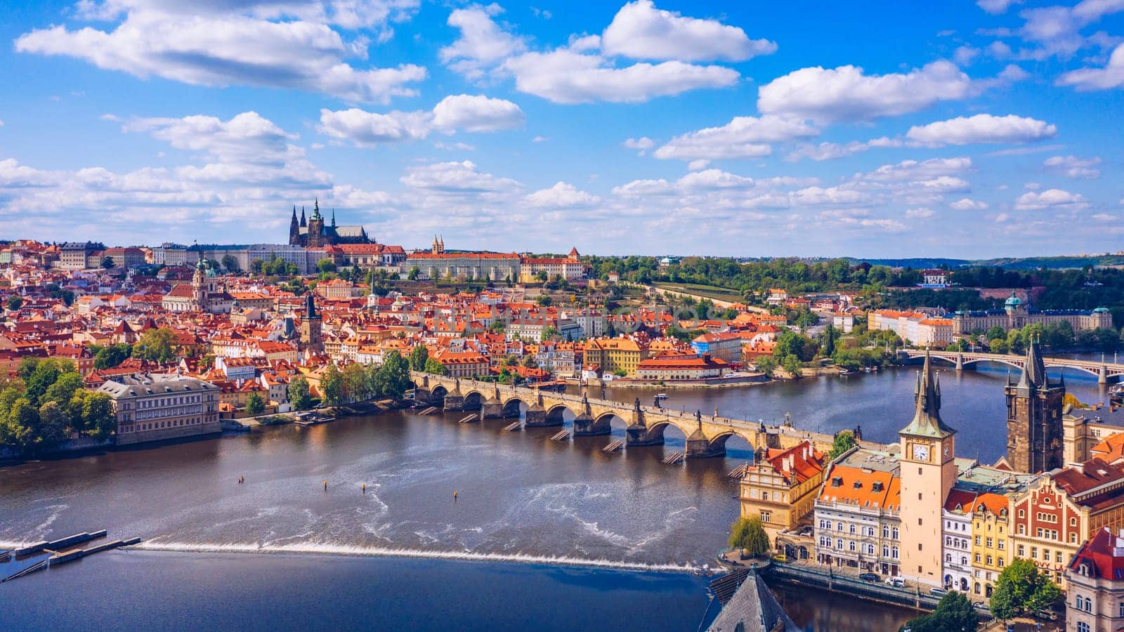 Prague scenic spring aerial view of the Prague Old Town pier architecture Charles Bridge over Vltava river in Prague, Czechia. Old Town of Prague with the Castle in the background, Czech Republic.