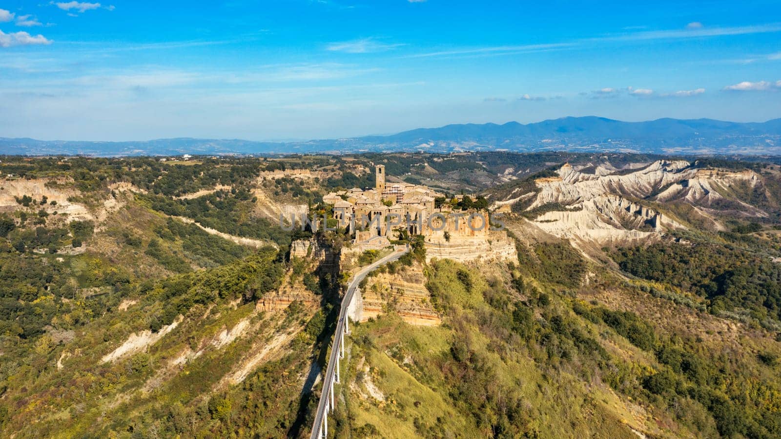 The famous Civita di Bagnoregio on a sunny day. Province of Viterbo, Lazio, Italy. Medieval town on the mountain, Civita di Bagnoregio, popular touristic stop at Tuscany, Italy.
