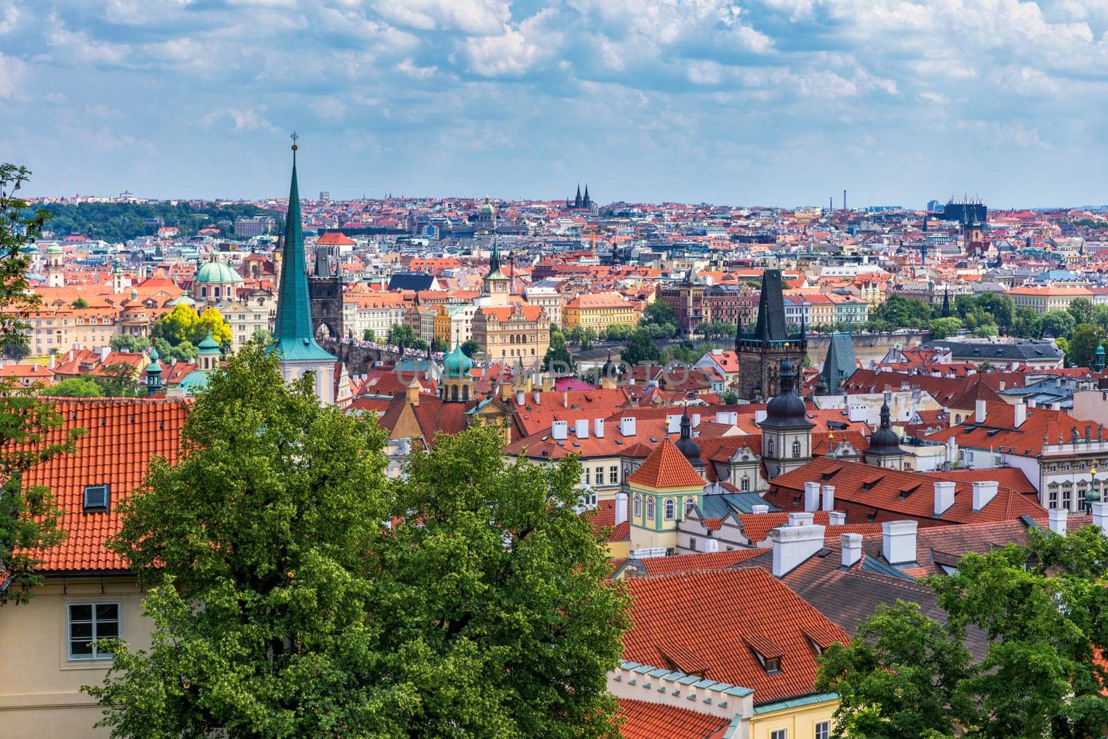 Old town of Prague. Czech Republic over river Vltava with Charles Bridge on skyline. Prague panorama landscape view with red roofs.  Prague view from Petrin Hill, Prague, Czechia.