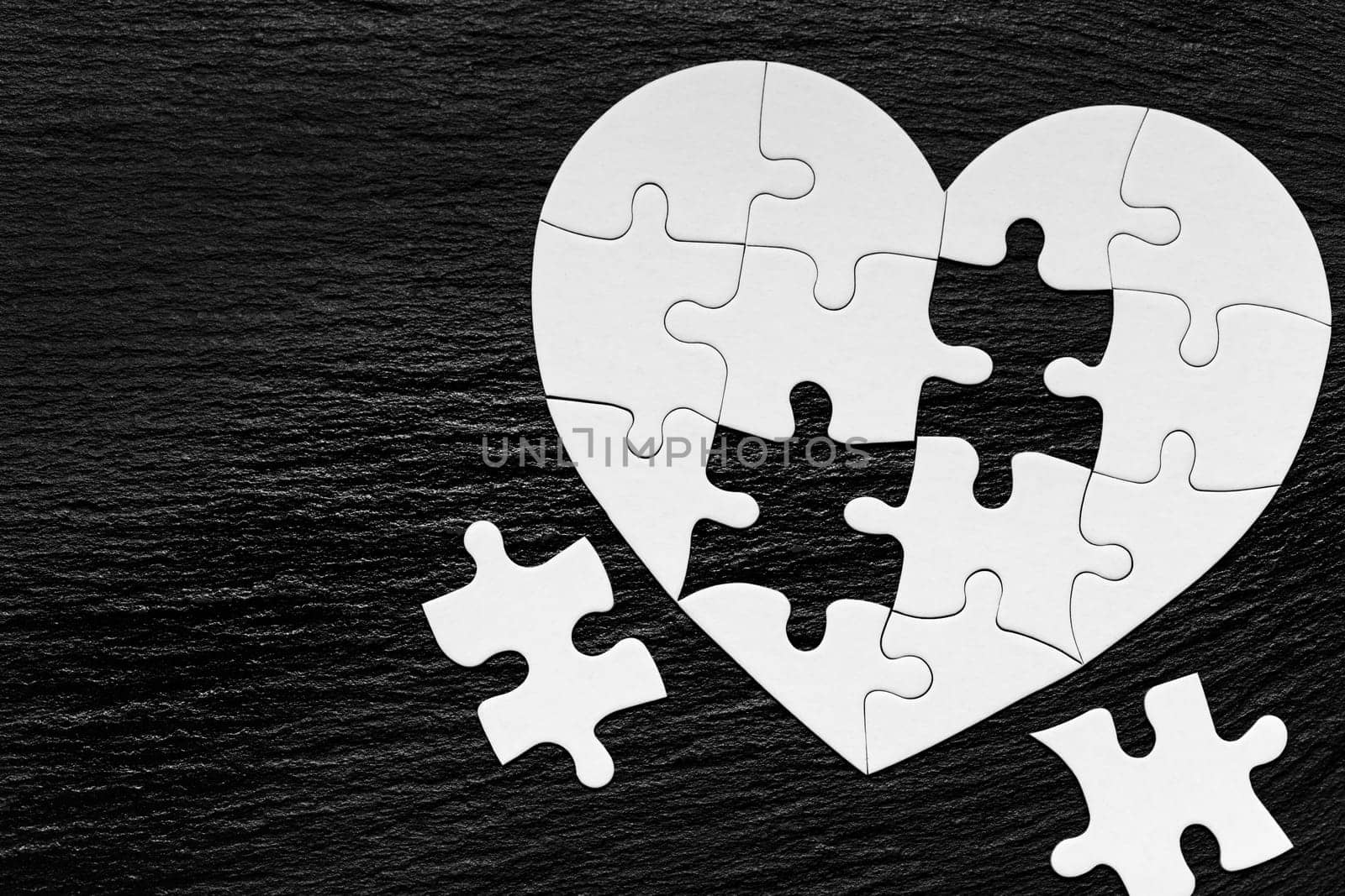 Heart object made of puzzle pieces. Make complete heart. Jigsaw puzzle pieces in form of heart. Happy Valentines Day, greeting card template. Heart jigsaw puzzle.