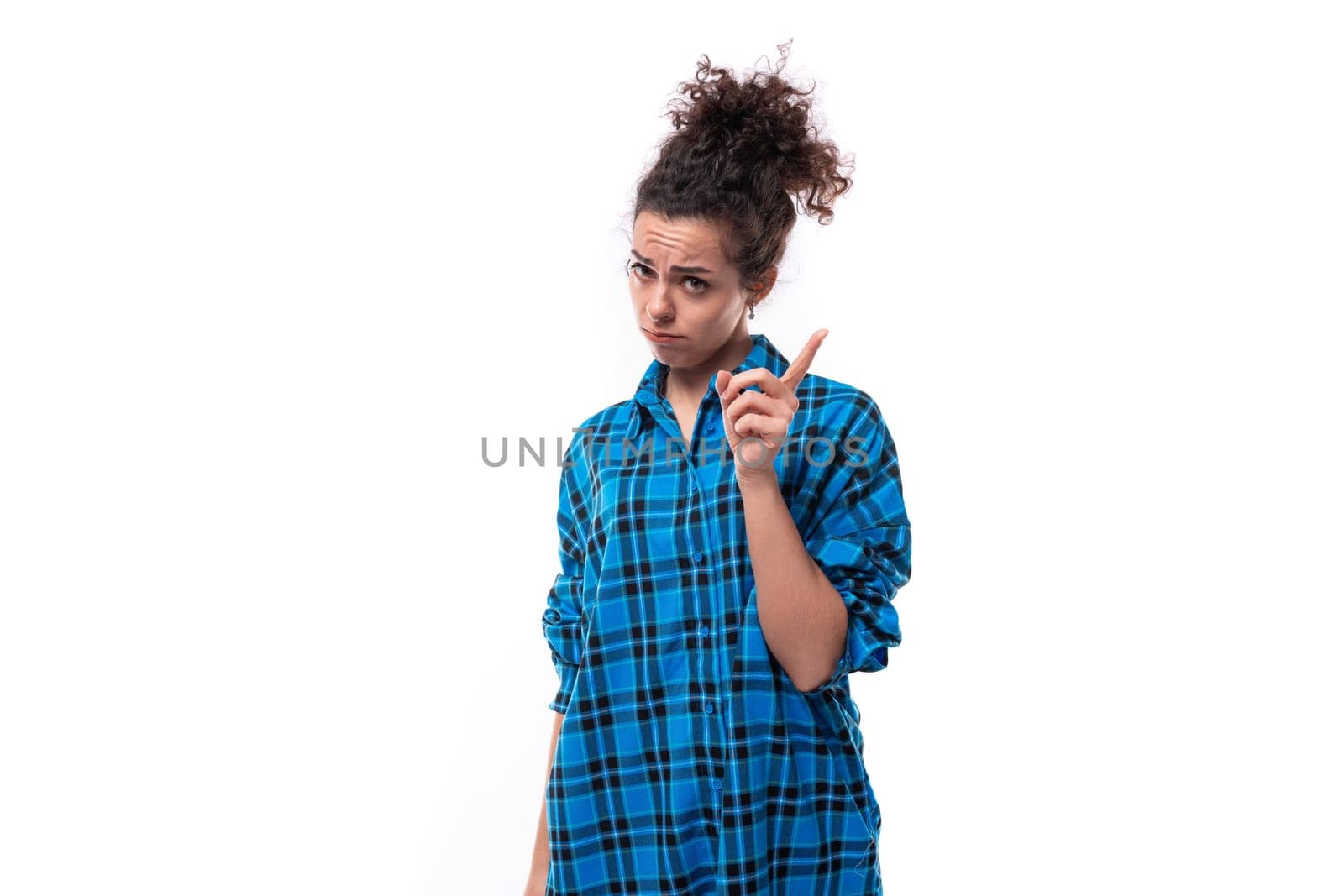 young smart woman dressed in casual shirt shows index finger up by TRMK