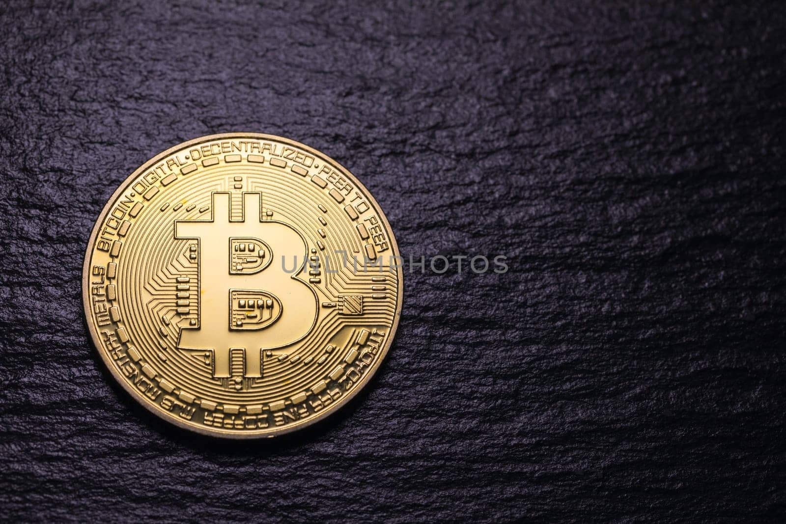 Bitcoin gold coin on dark textured background. Bitcoin & Cryptocurrency. Bitcoin. Crypto currency Gold Bitcoin, BTC, Bit Coin. Macro shot of Bitcoin coins isolated on black background.