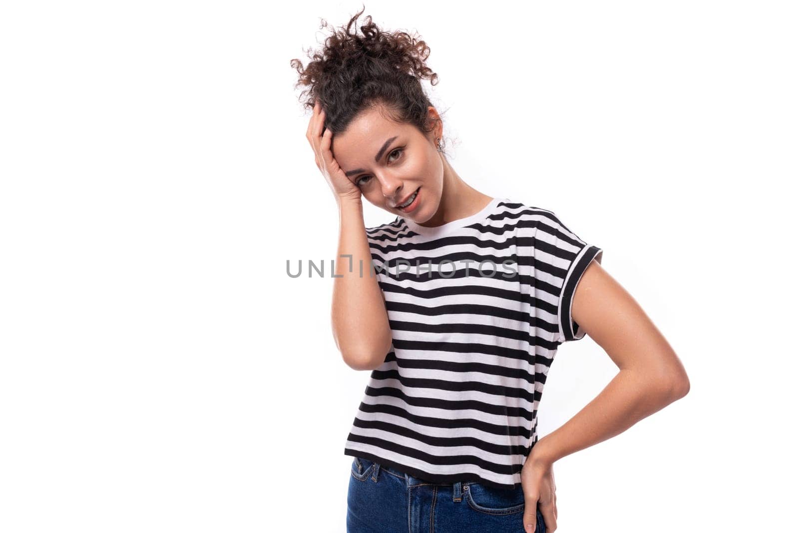young caucasian woman with curly hair dressed in a striped summer t-shirt is brainstorming.