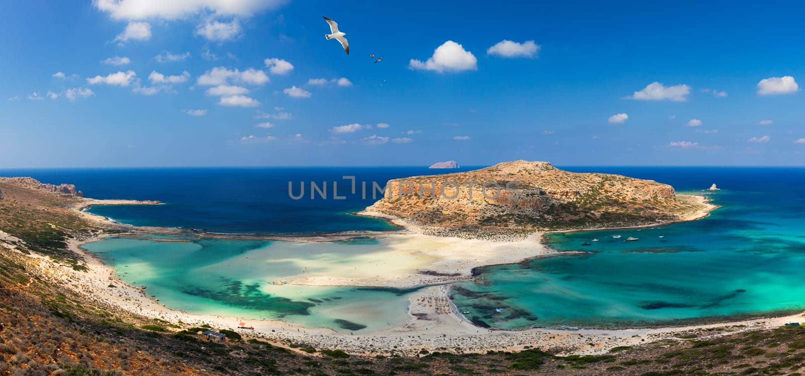 Balos Lagoon and Gramvousa island on Crete with seagulls flying over, Greece. Cap tigani in the center. Balos beach on Crete island, Greece. Crystal clear water of Balos beach.