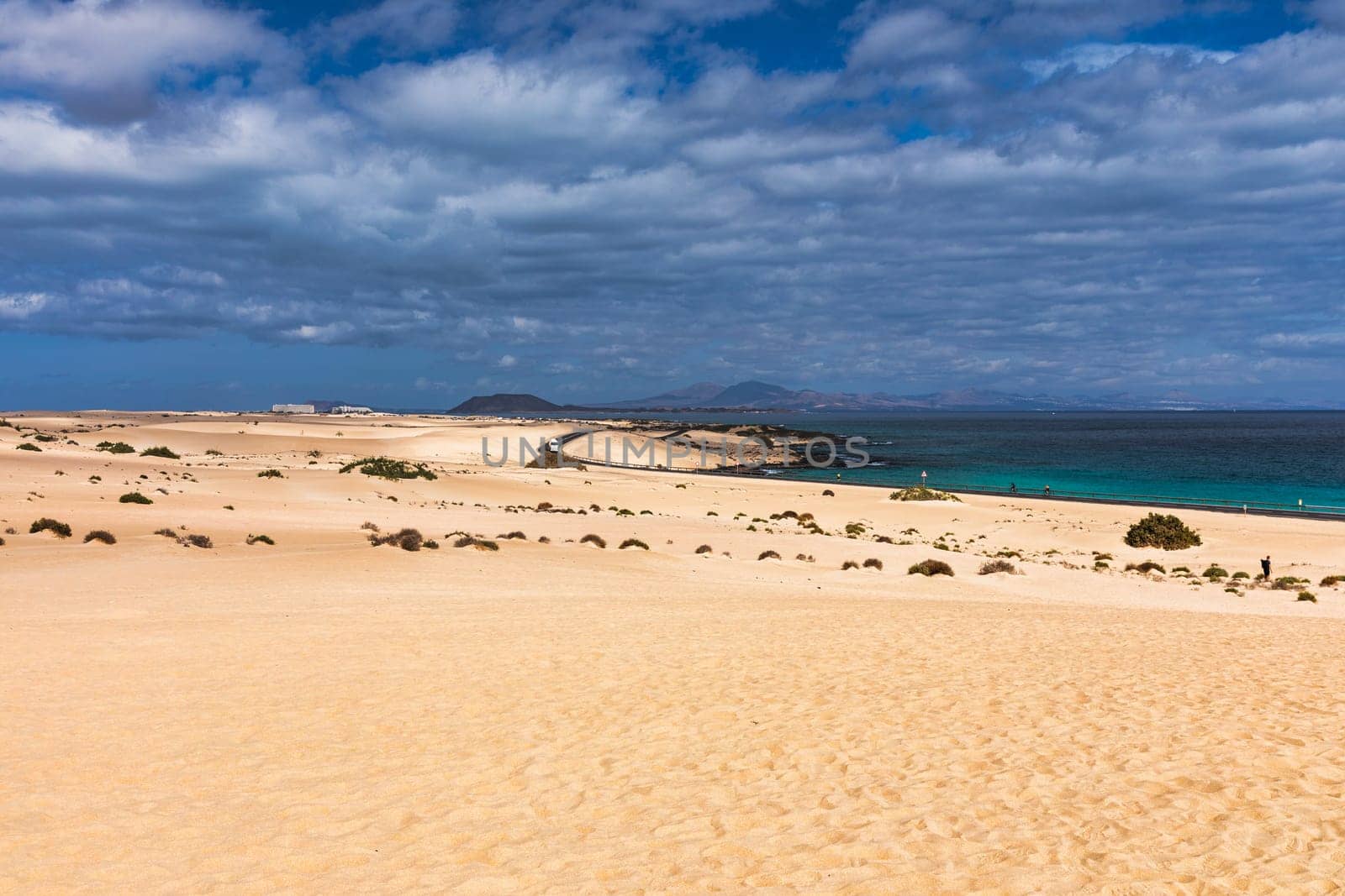 Sand dunes, Las Dunas de Corralejo, Corralejo Natural Park, dramatic cloud formation, Fuerteventura, Canary Islands, Spain. Sand dunes landscape, Corralejo, Fuerteventura, Canary Islands, Spain.