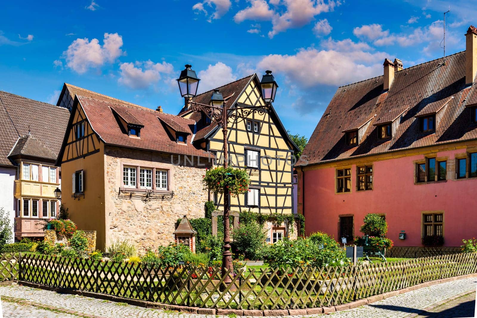 Traditional timbered house in Turckheim, Alsace, France. One of the famous cities in Alsace scenic route near Colmar, France. Colorful traditional french houses in Turckheim town of Alsace, France. by DaLiu