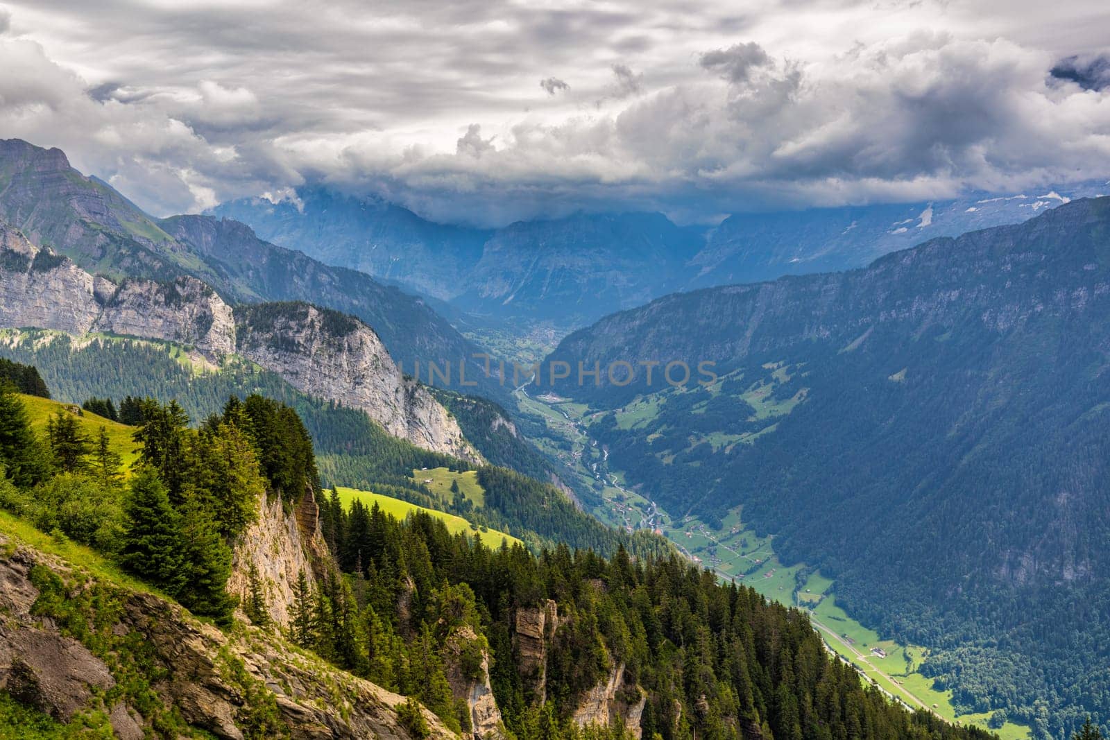 Grindelwald view and summer Swiss Alps mountains panorama landscape, green fields and high peaks in background, Switzerland, Bernese Oberland, Europe. by DaLiu