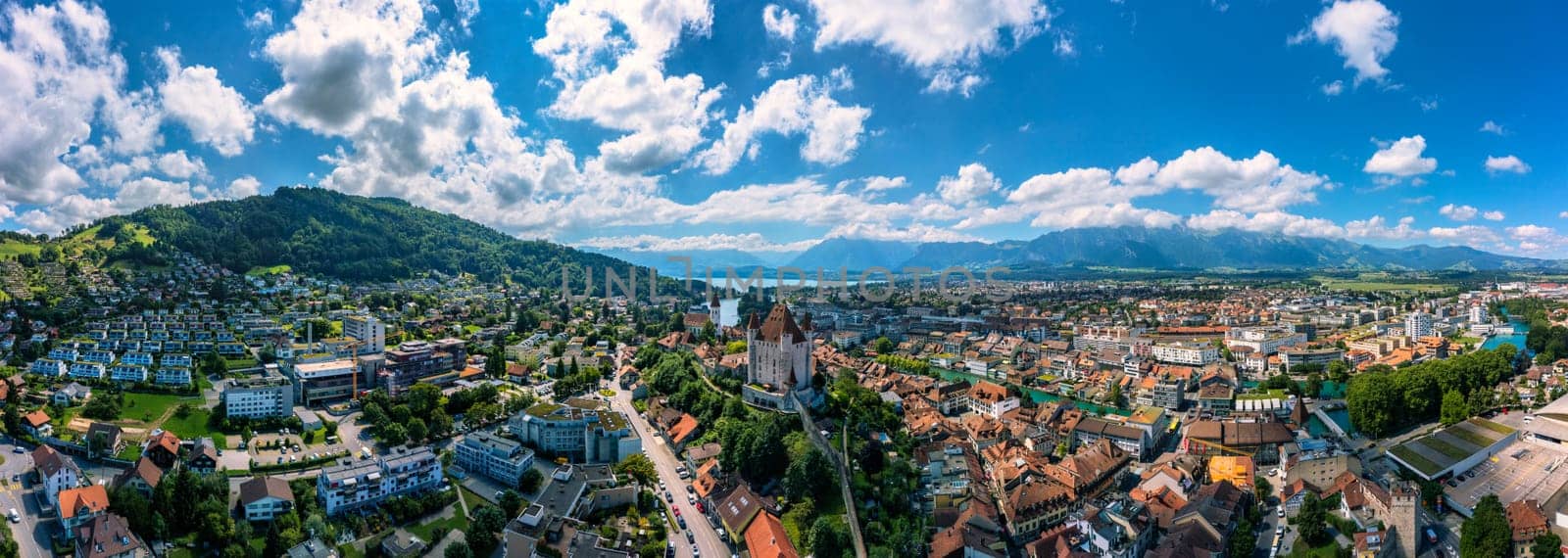 Panorama of Thun city with Alps and Thunersee lake, Switzerland. Historical Thun city and lake Thun with Bernese Highlands swiss Alps mountains in background, Canton Bern, Switzerland.