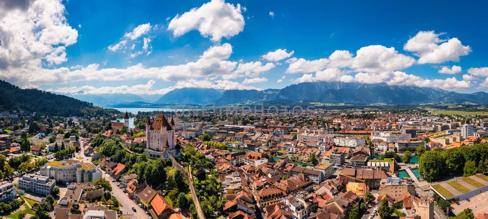 Panorama of Thun city with Alps and Thunersee lake, Switzerland. Historical Thun city and lake Thun with Bernese Highlands swiss Alps mountains in background, Canton Bern, Switzerland.