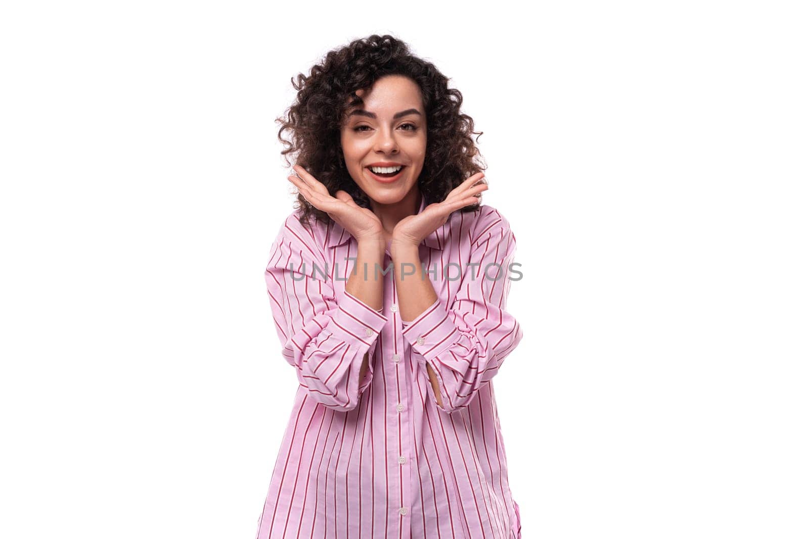 young brunette curly caucasian woman dressed in a striped pink blouse isolated on white background. people lifestyle concept.