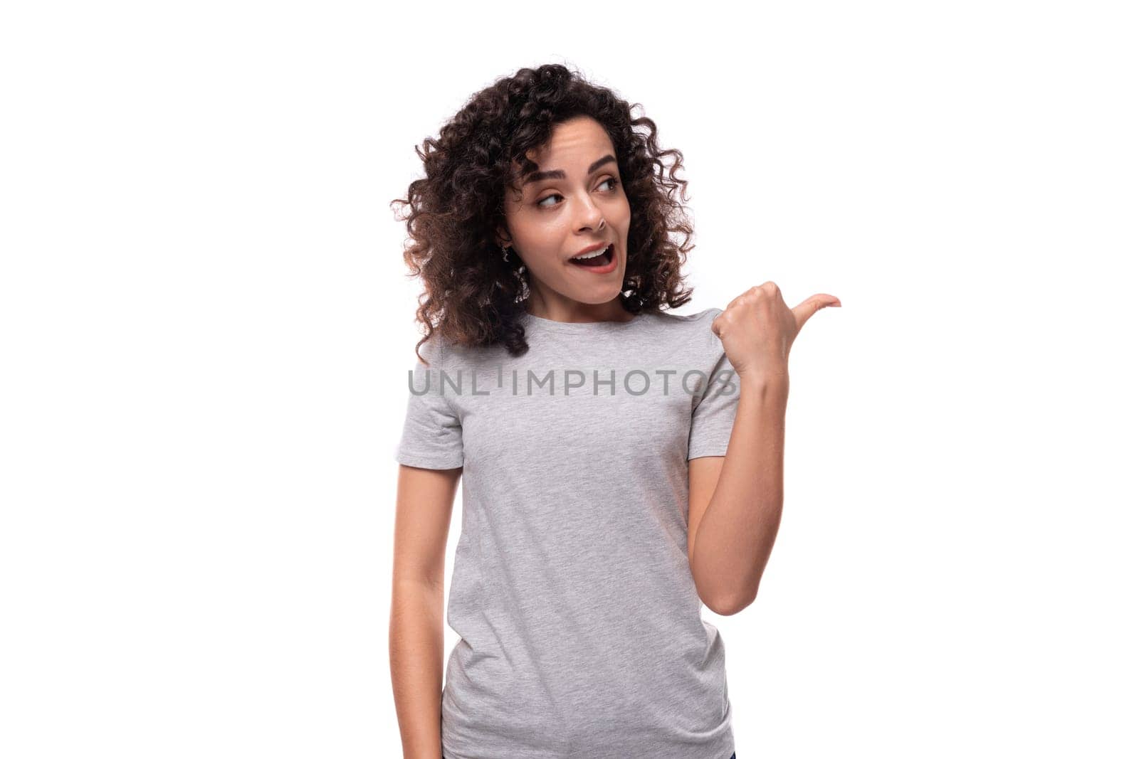 charming curly brunette promoter woman dressed in gray t-shirt with mockup for print on white background by TRMK