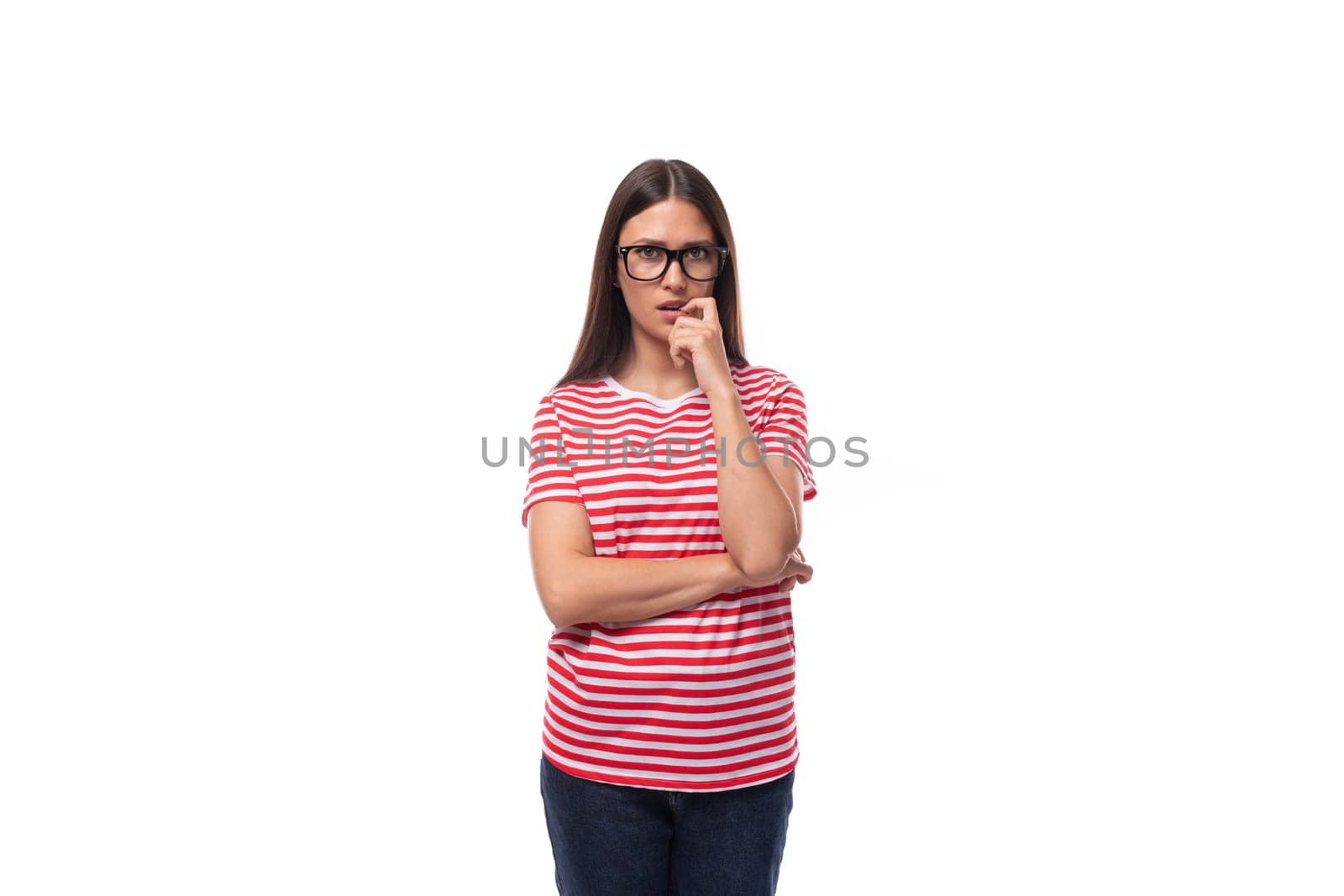 thoughtful frustrated young caucasian woman with straight hair with glasses and in a striped t-shirt thinks about the problem and the solution.