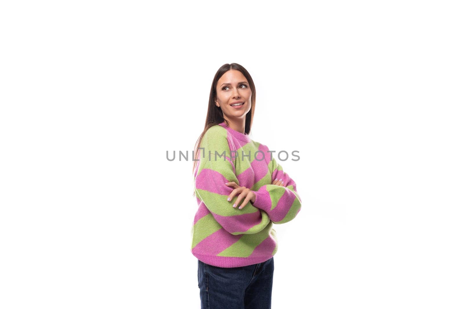 pretty young european brunette woman dressed in a striped pink pullover on a white background with copy space.