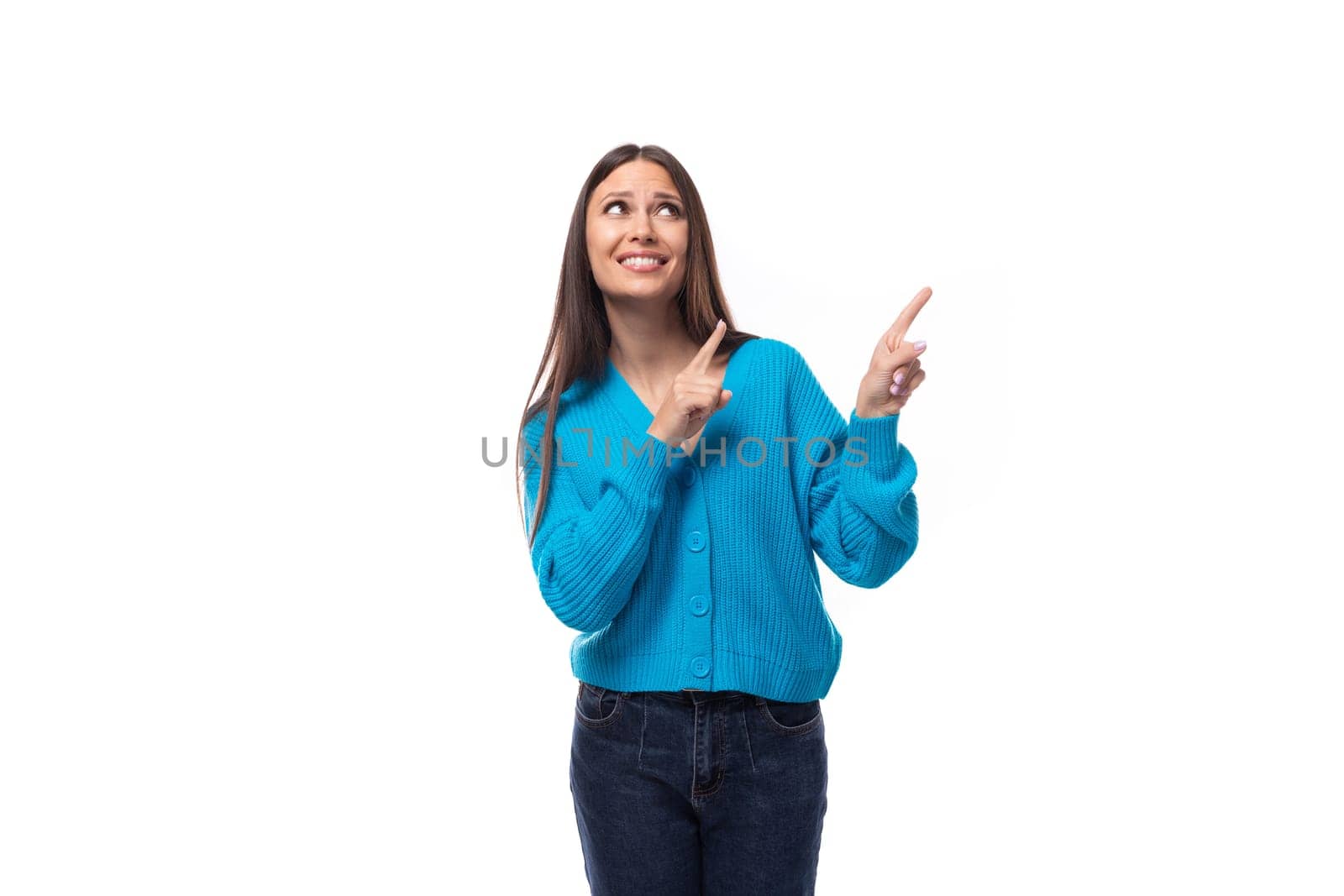 cheerful smiling caucasian woman with black hair shows her hands in different directions on copy space.