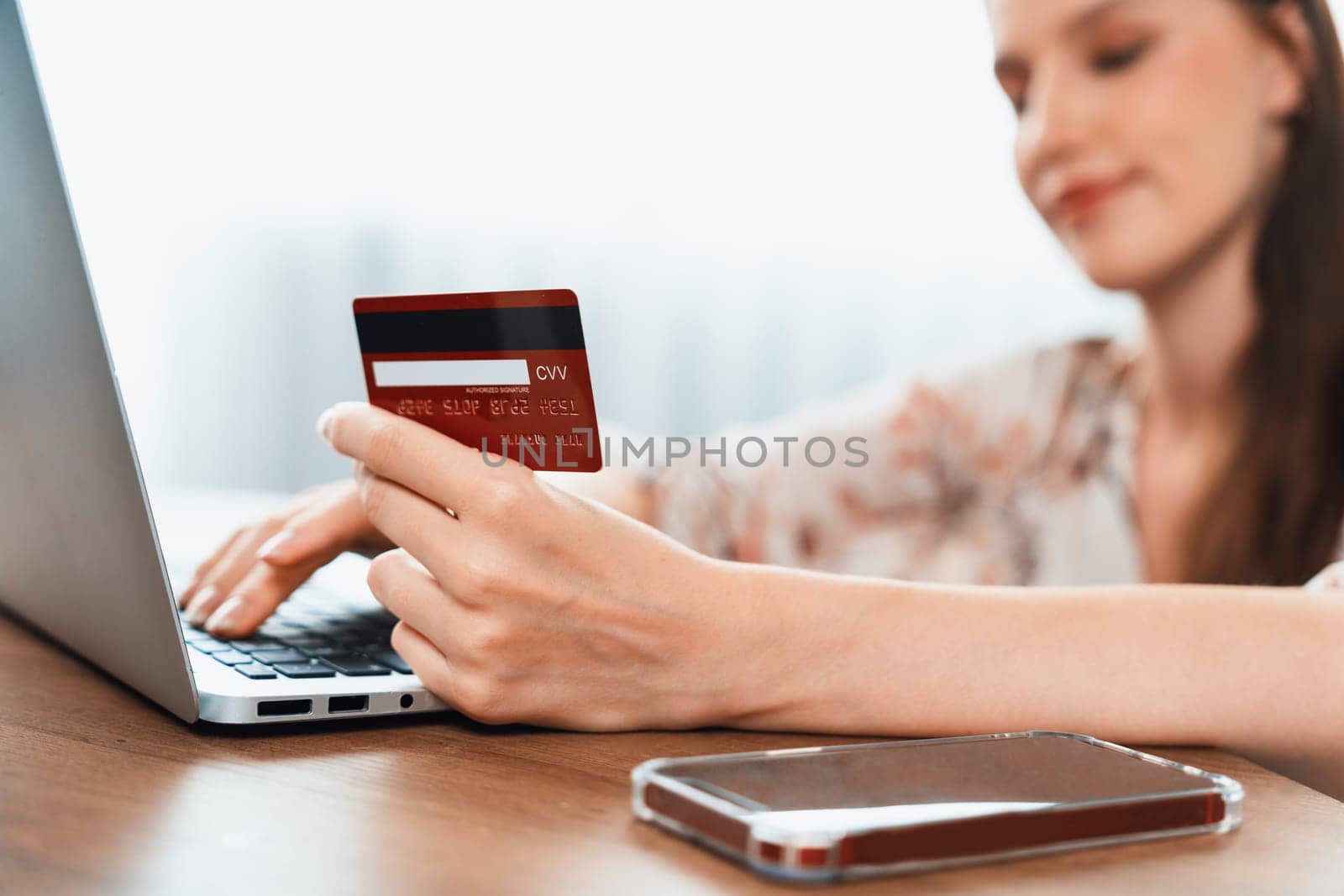 Close up credit card using for online payment, banking and shopping on the internet network with laptop computer showing credit card technology for online secured wallet top up and utmost purchase