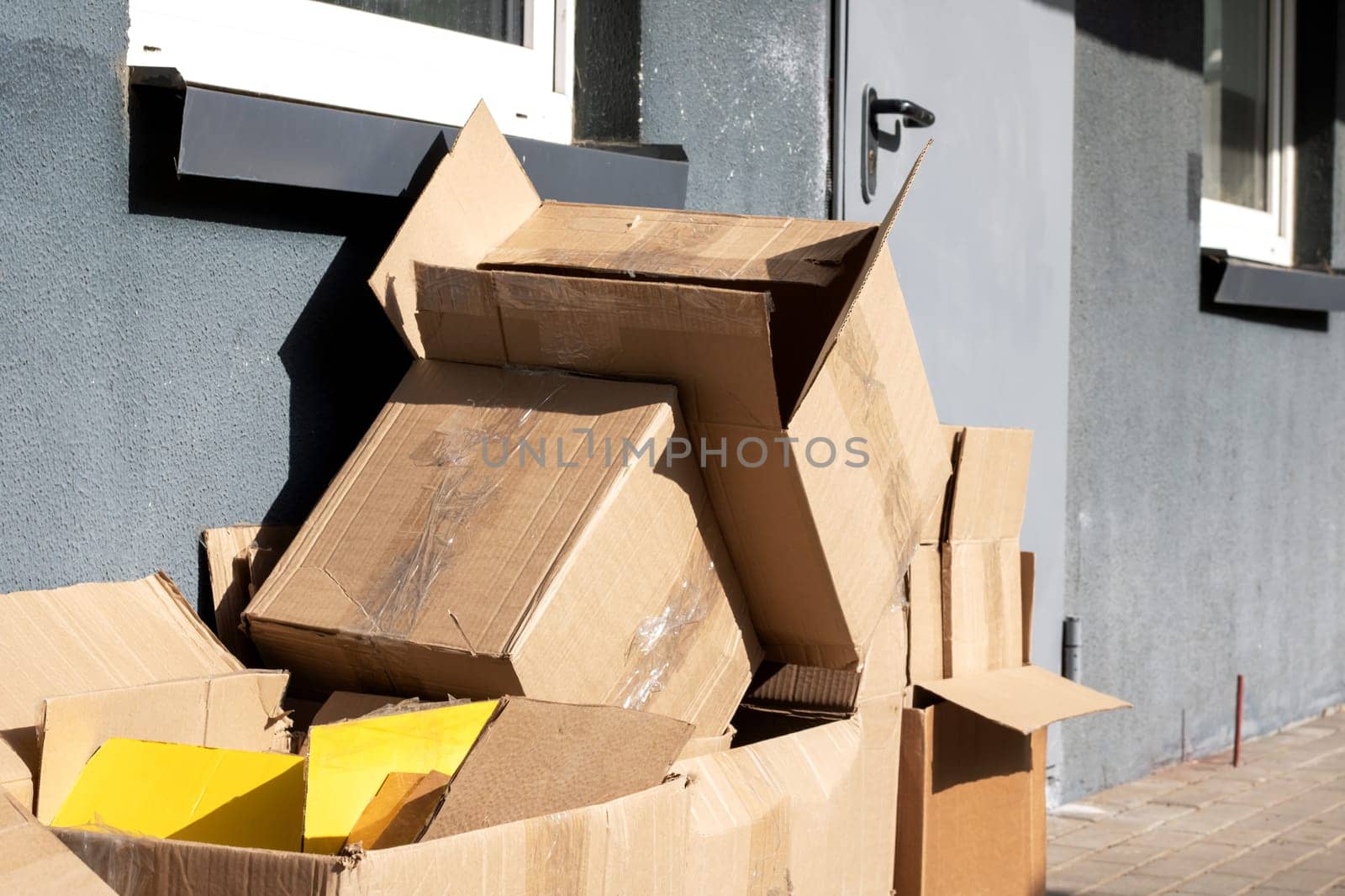 Empty cardboard boxes after moving close up in sunlight