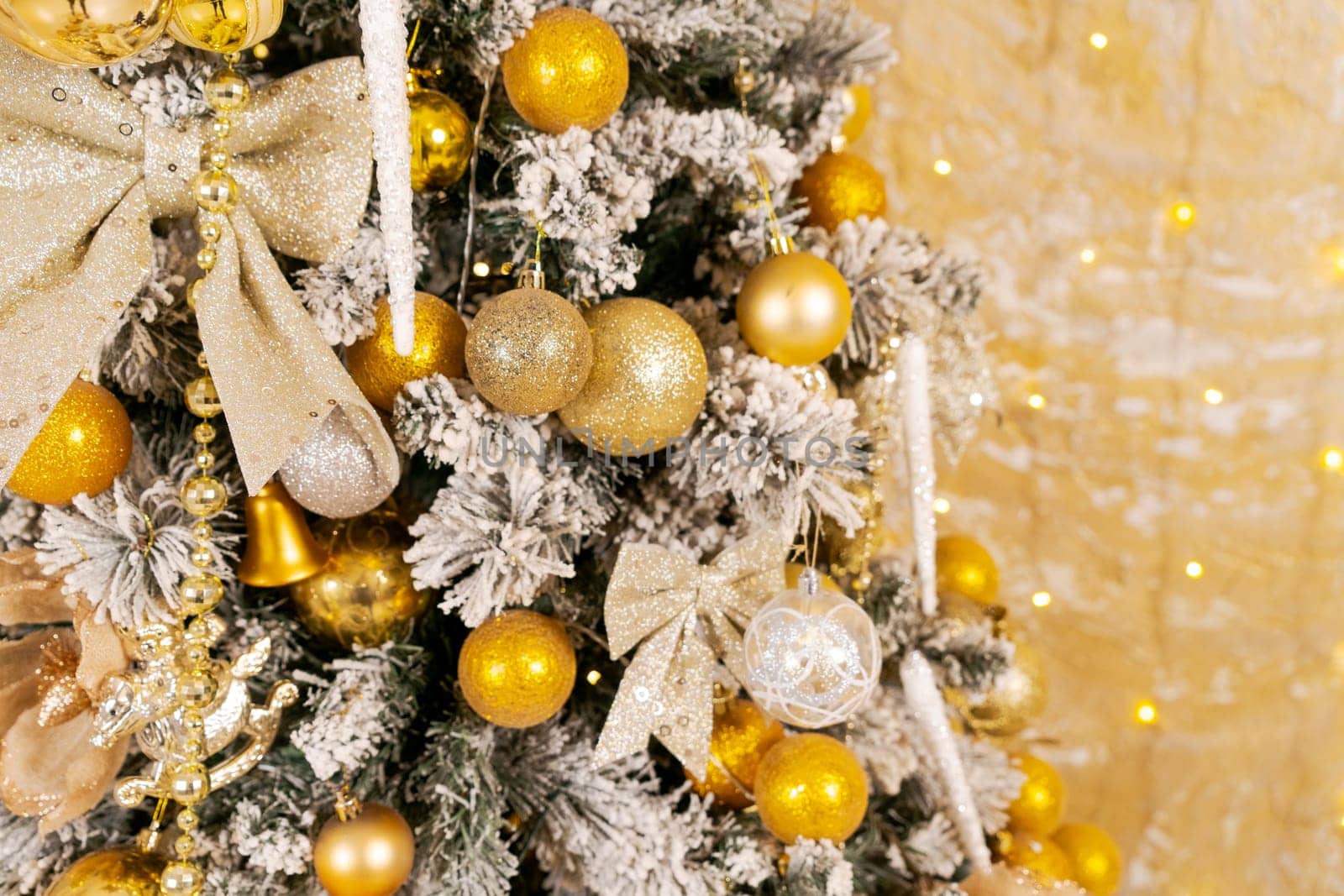 Christmas tree decorated with Golden balls toys on blurred, sparkling by EkaterinaPereslavtseva