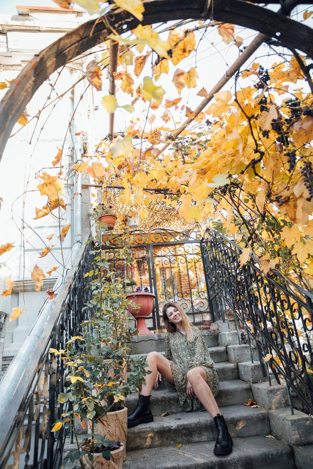 Woman sitting on steps in autumn park Walk by Simakov