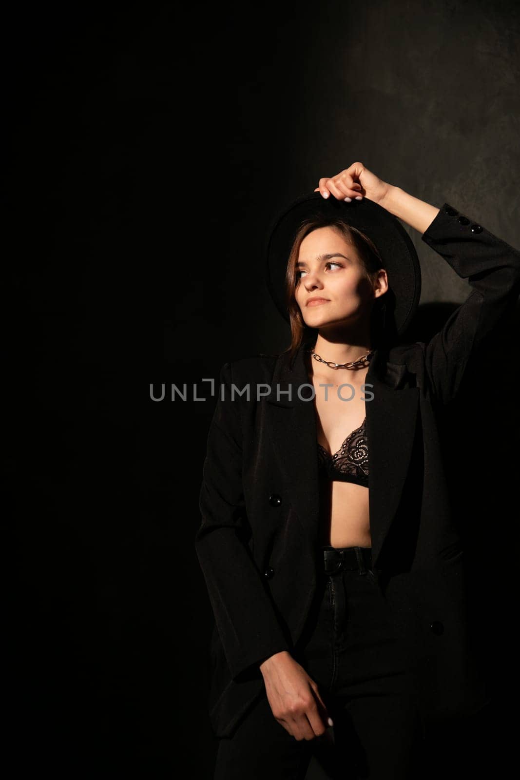 Woman in black clothes posing in room