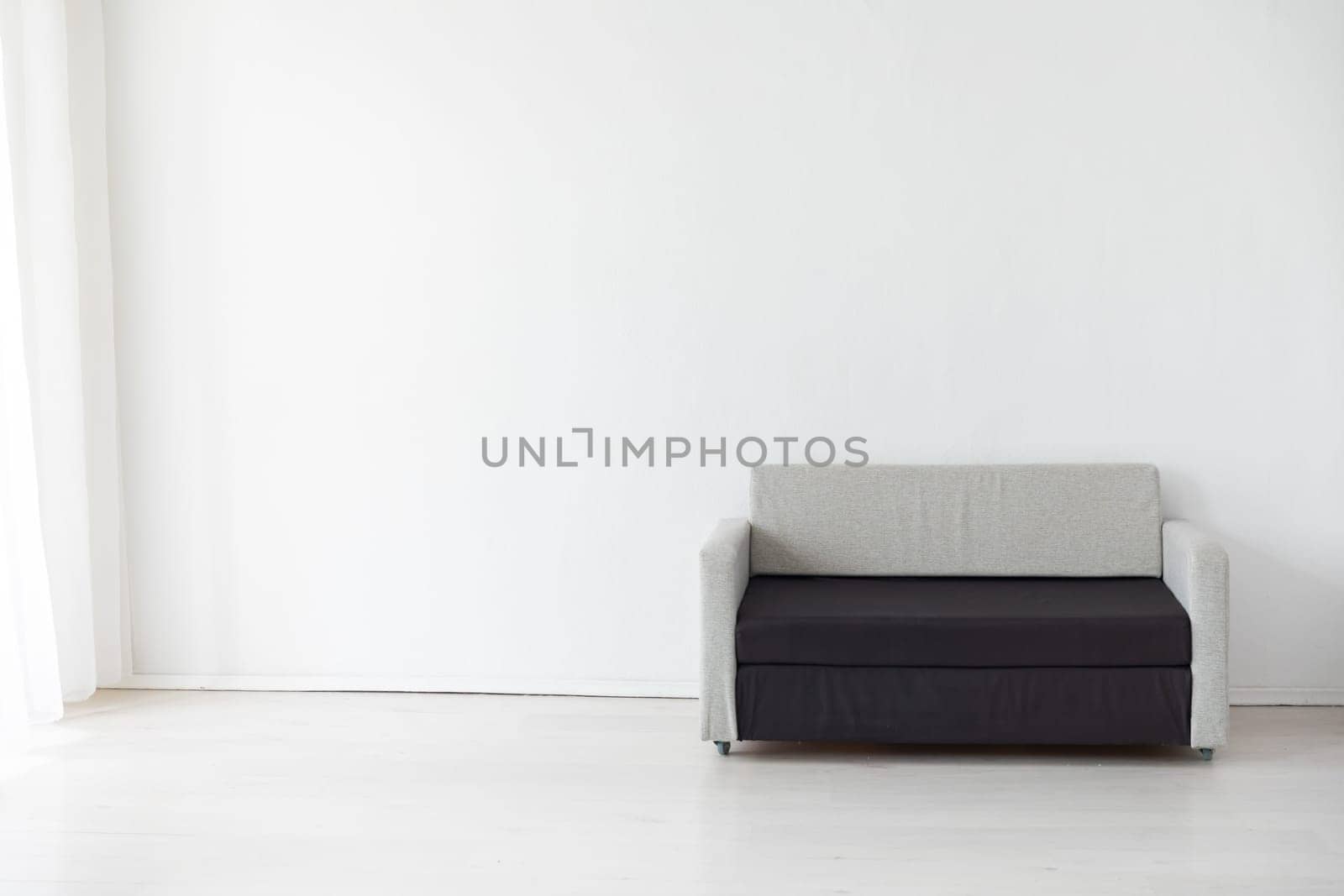 sofa in a bright room against a white wall by Simakov