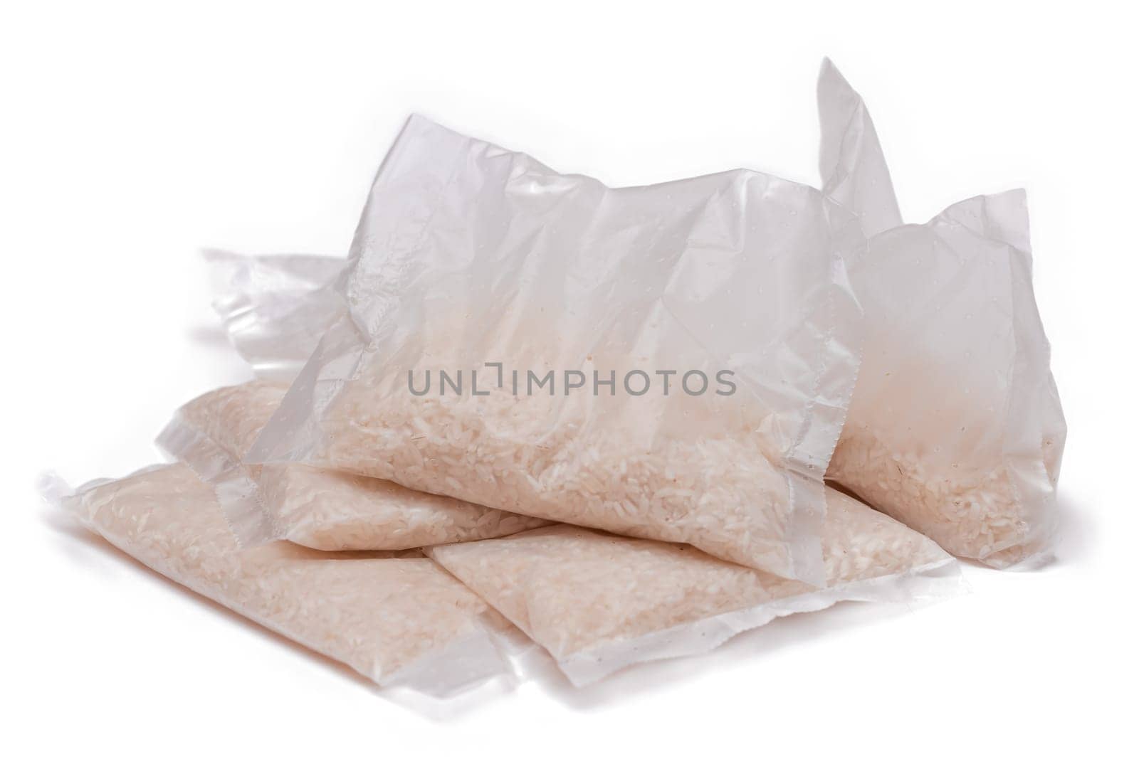 A Plastic Bags of White Long Grain Rice - Isolated on White Background. Small Transparent Packages with Dry Rice - Isolation