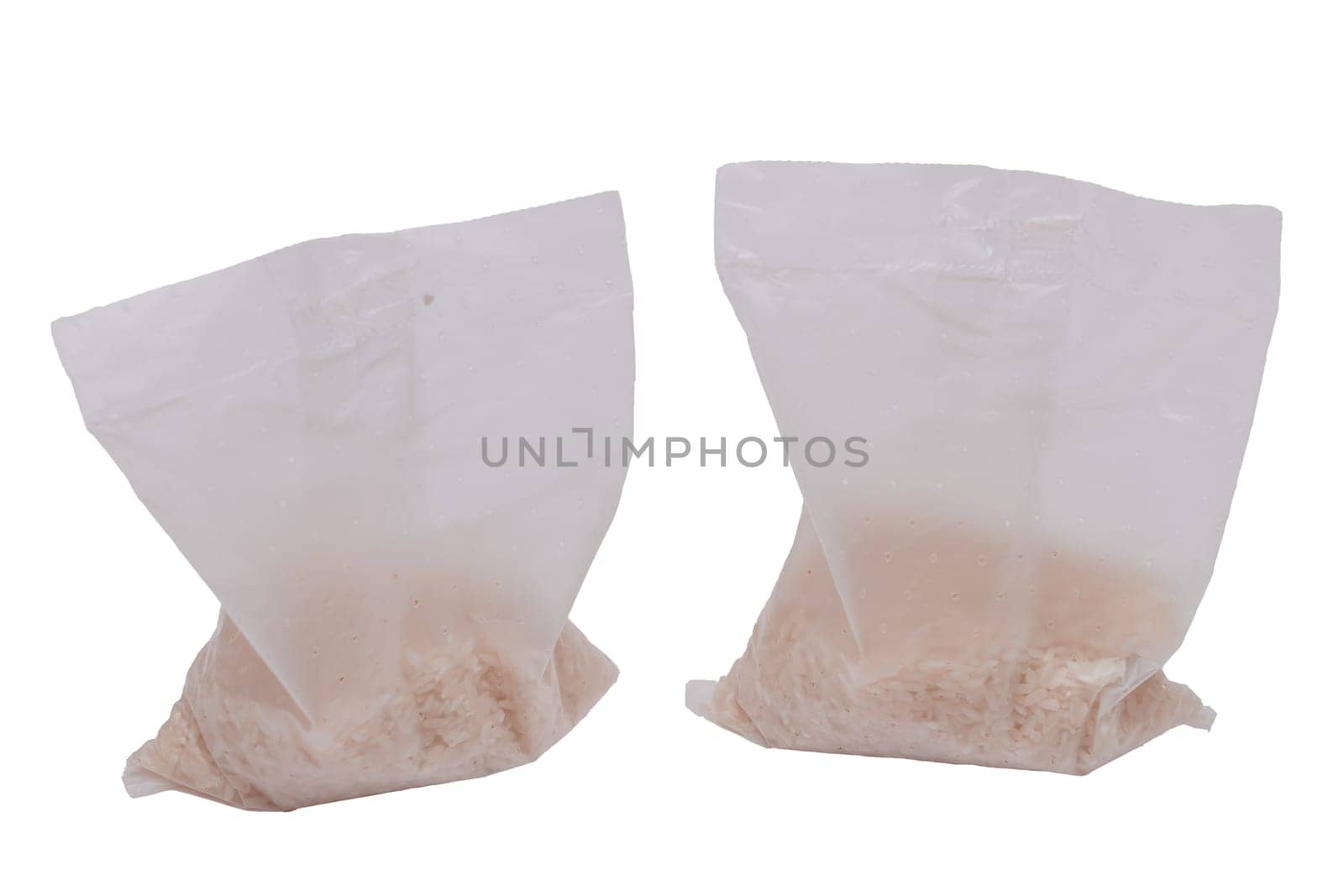 A Plastic Bags of White Long Grain Rice - Isolated on White Background. Small Transparent Packages with Dry Rice - Isolation