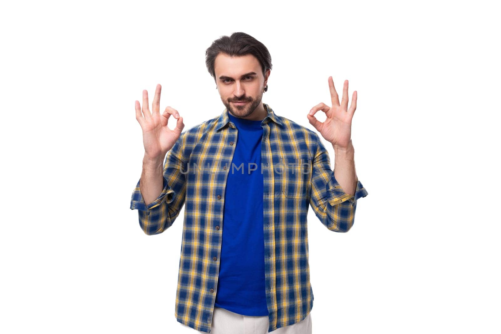 portrait of a young european brunette with a beard waving his arms wide.