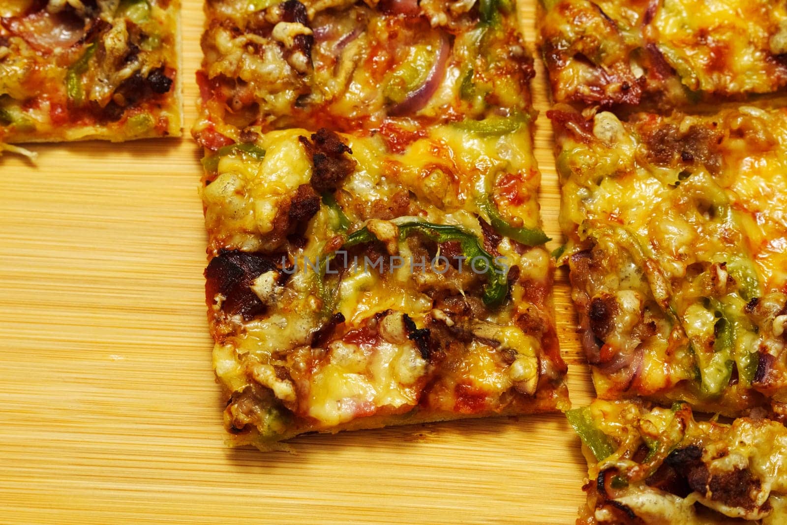 St. Louis-Style Pizza homemade on a wooden background, with cheese, pepper, bacon onion