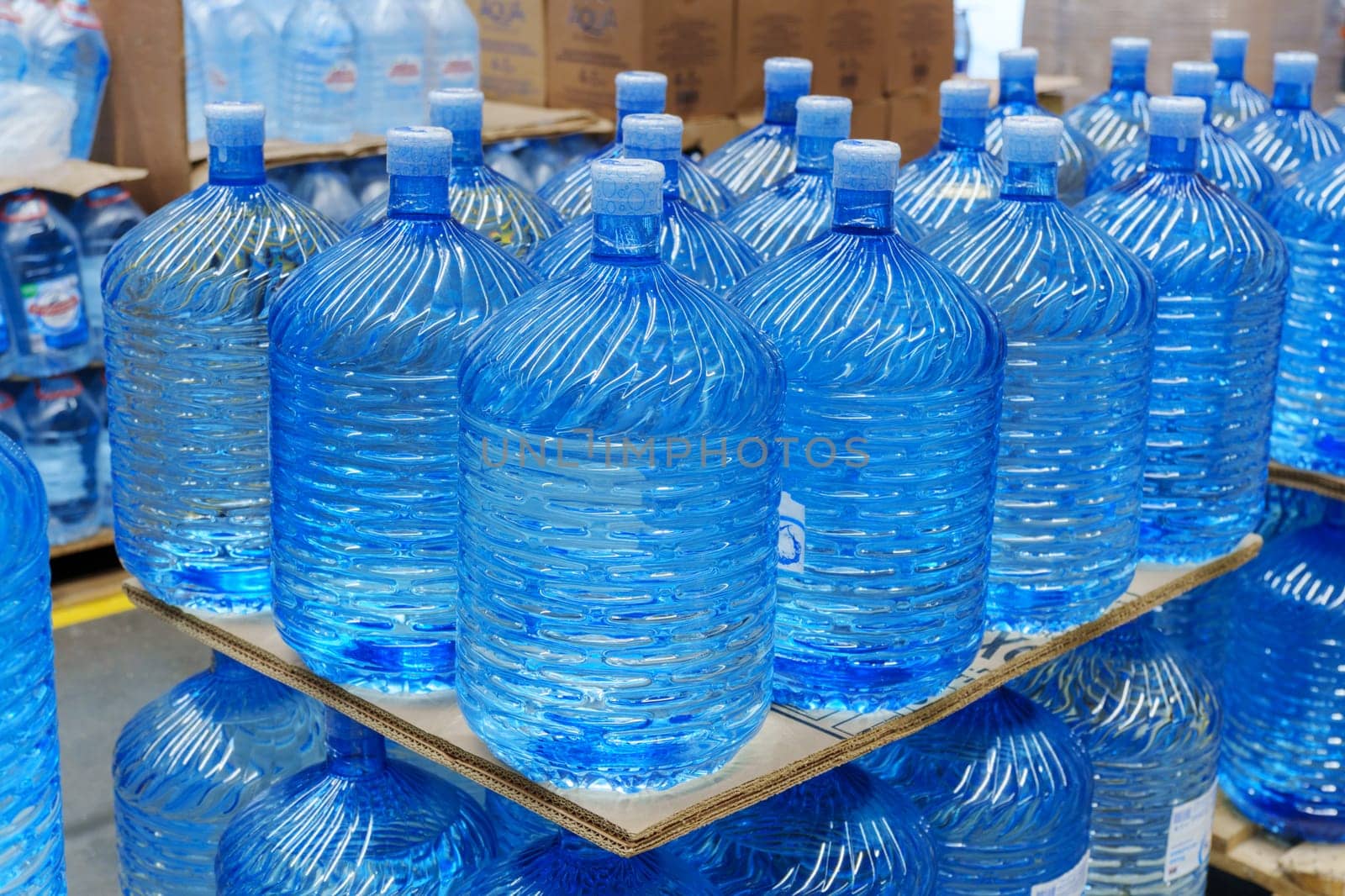 Bottles with clean water in a hyper package. Sale of drinking water. Selective focus